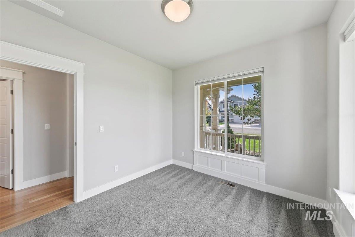 Empty room featuring carpet floors and baseboards