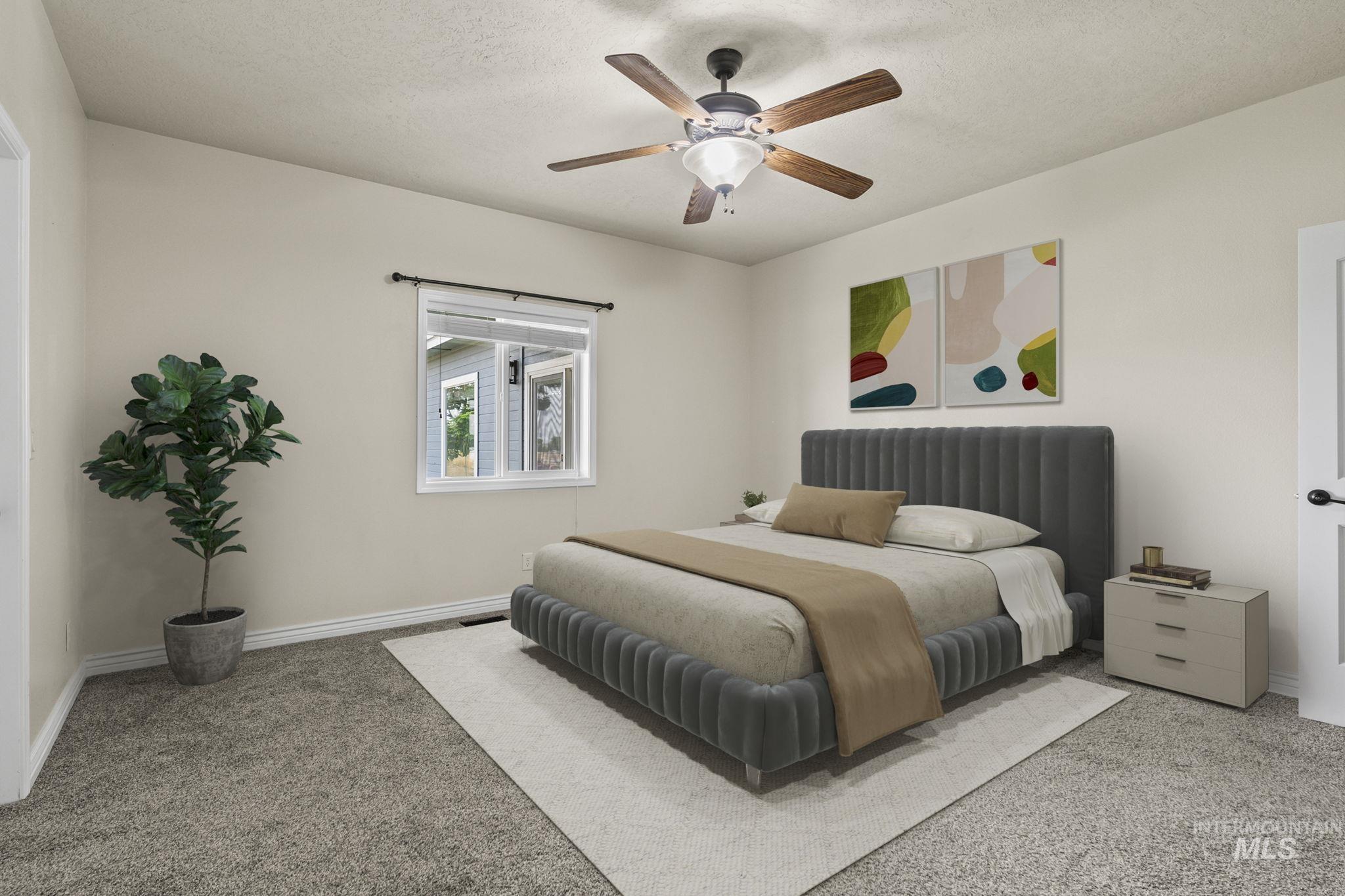 Bedroom featuring a textured ceiling, carpet floors, and ceiling fan