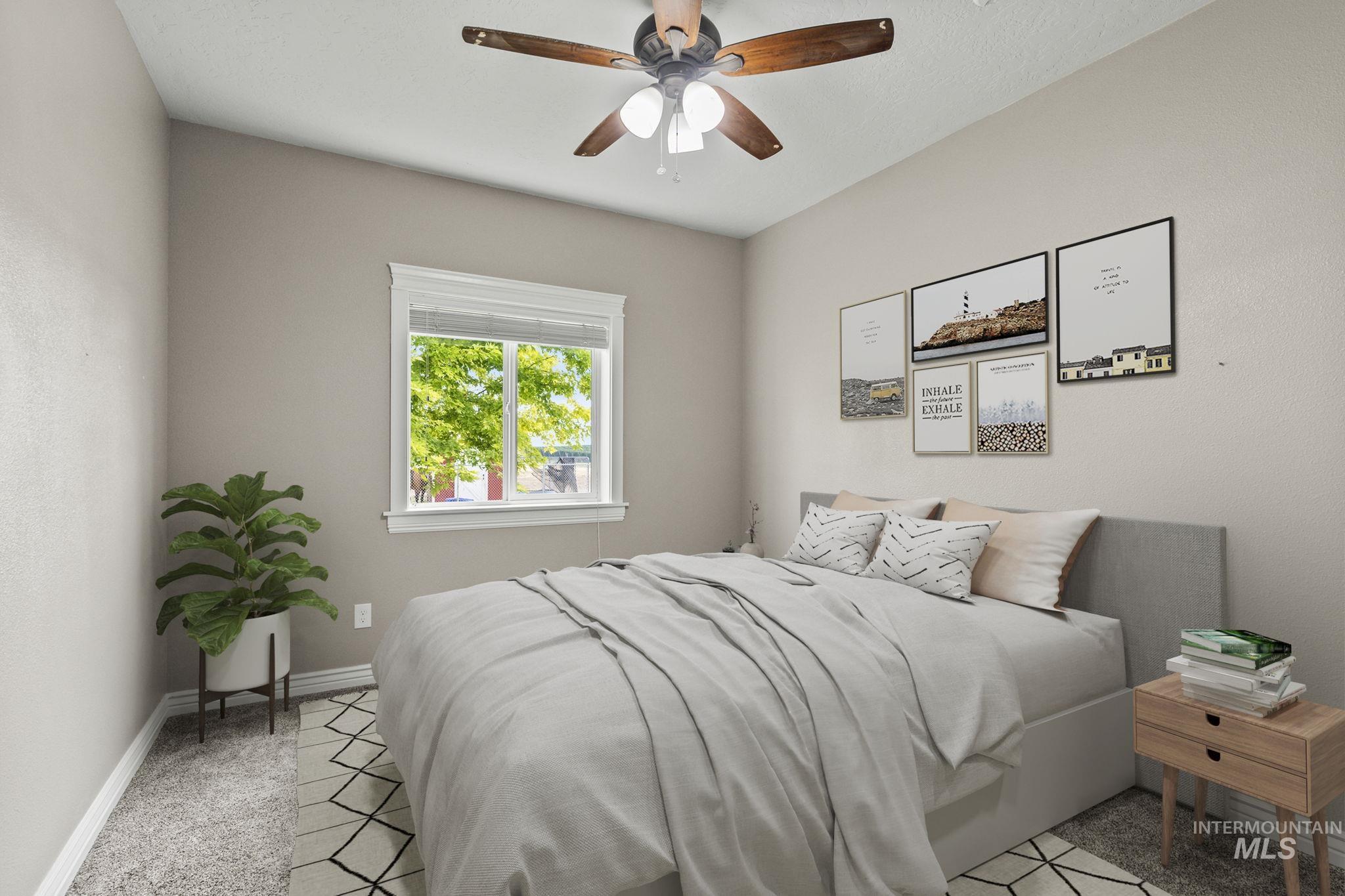 Bedroom featuring a ceiling fan and light carpet