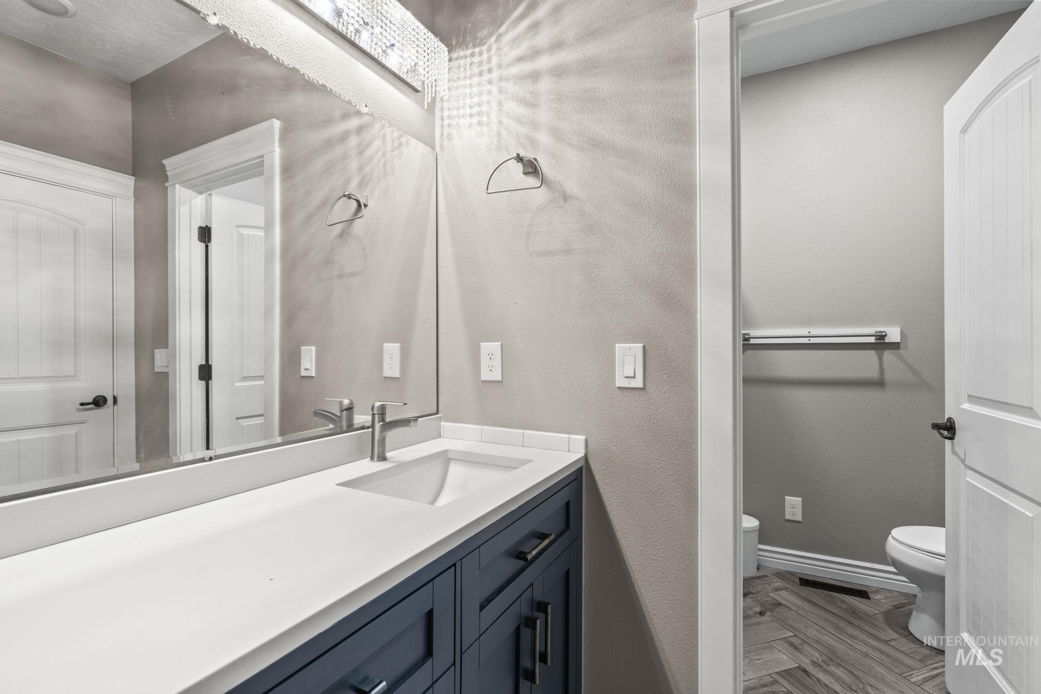 Bathroom with vanity and a textured wall
