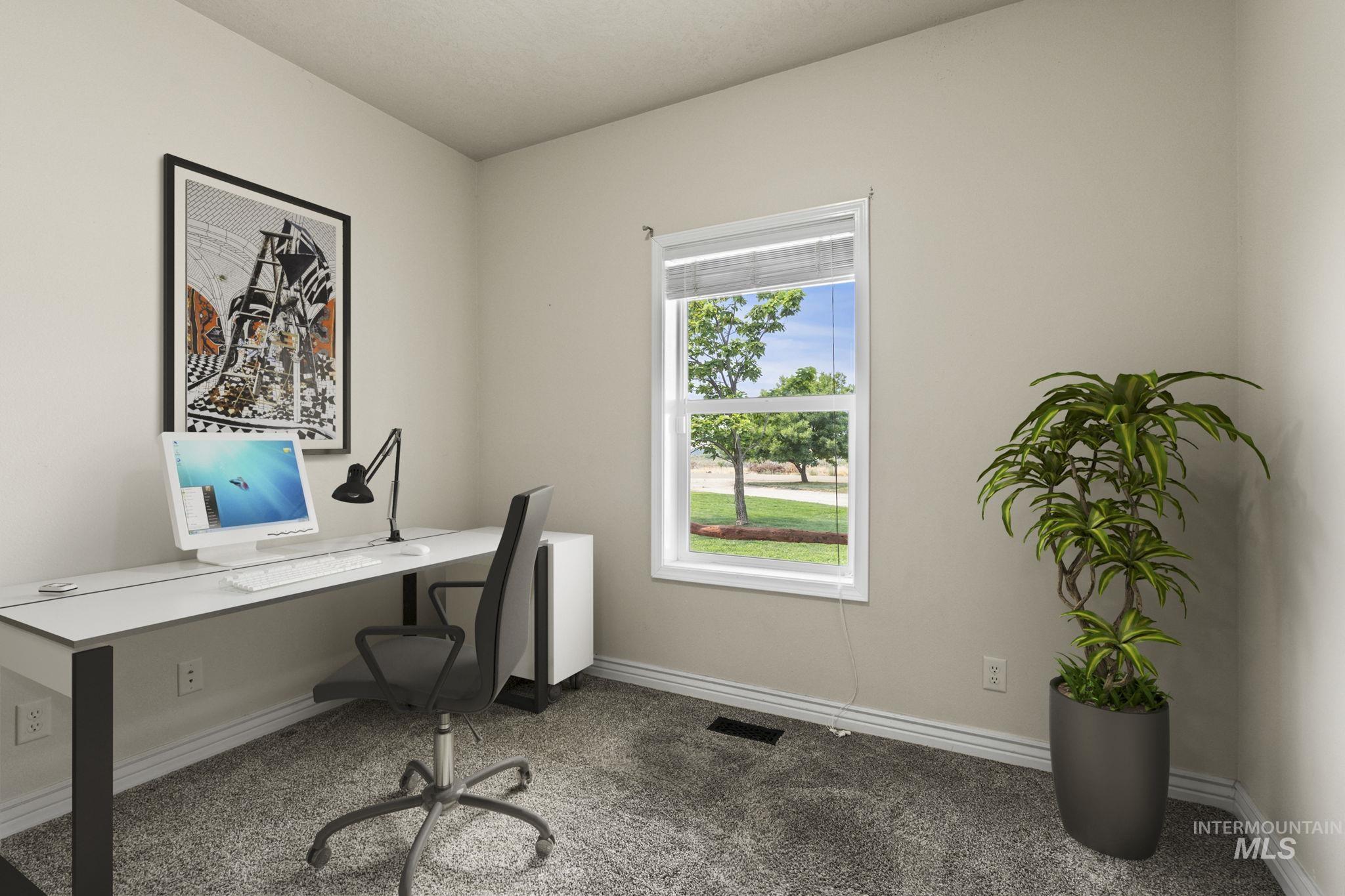Carpeted home office with baseboards