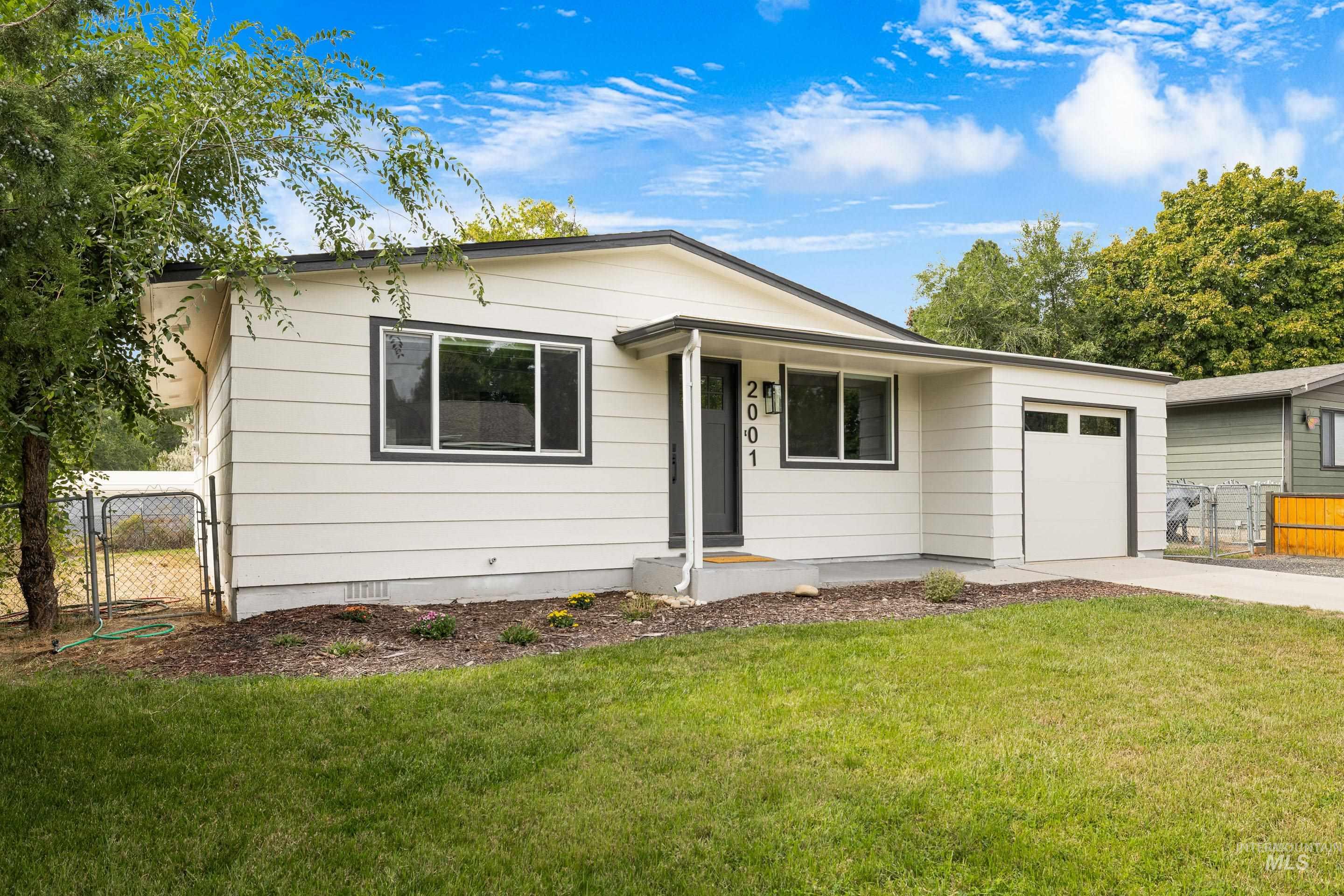 Ranch-style home featuring crawl space, a gate, driveway, and an attached garage