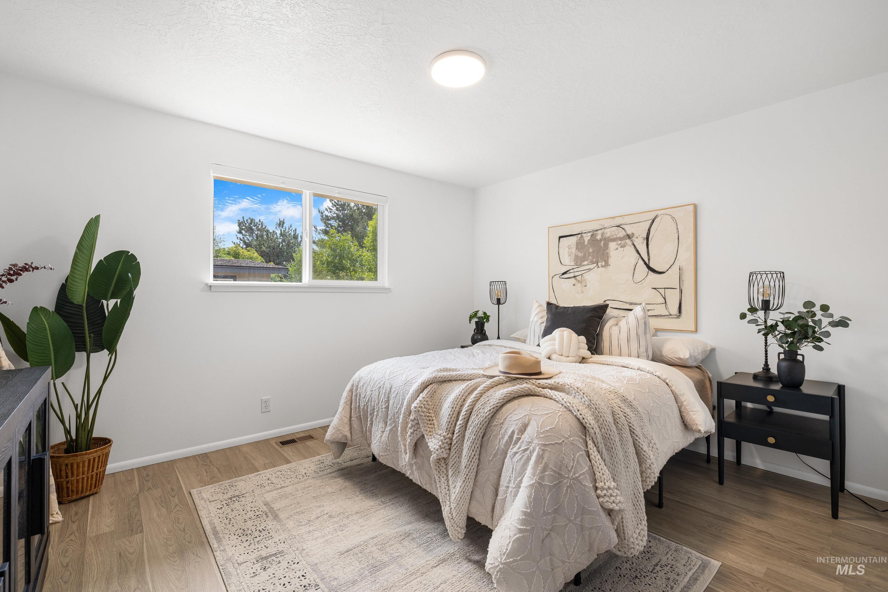 Bedroom featuring light wood-style flooring and a textured ceiling
