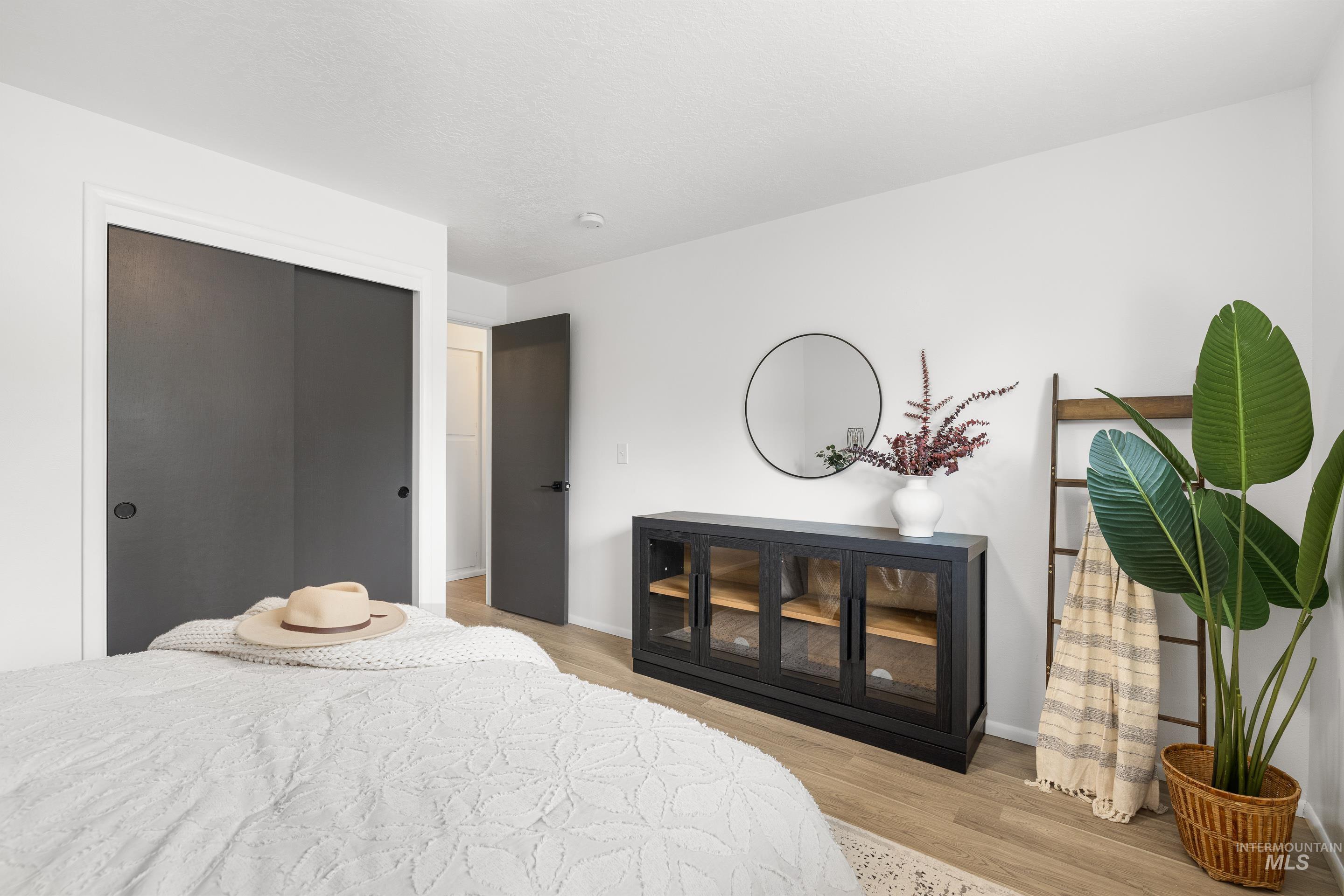 Bedroom with light wood-style flooring and a closet