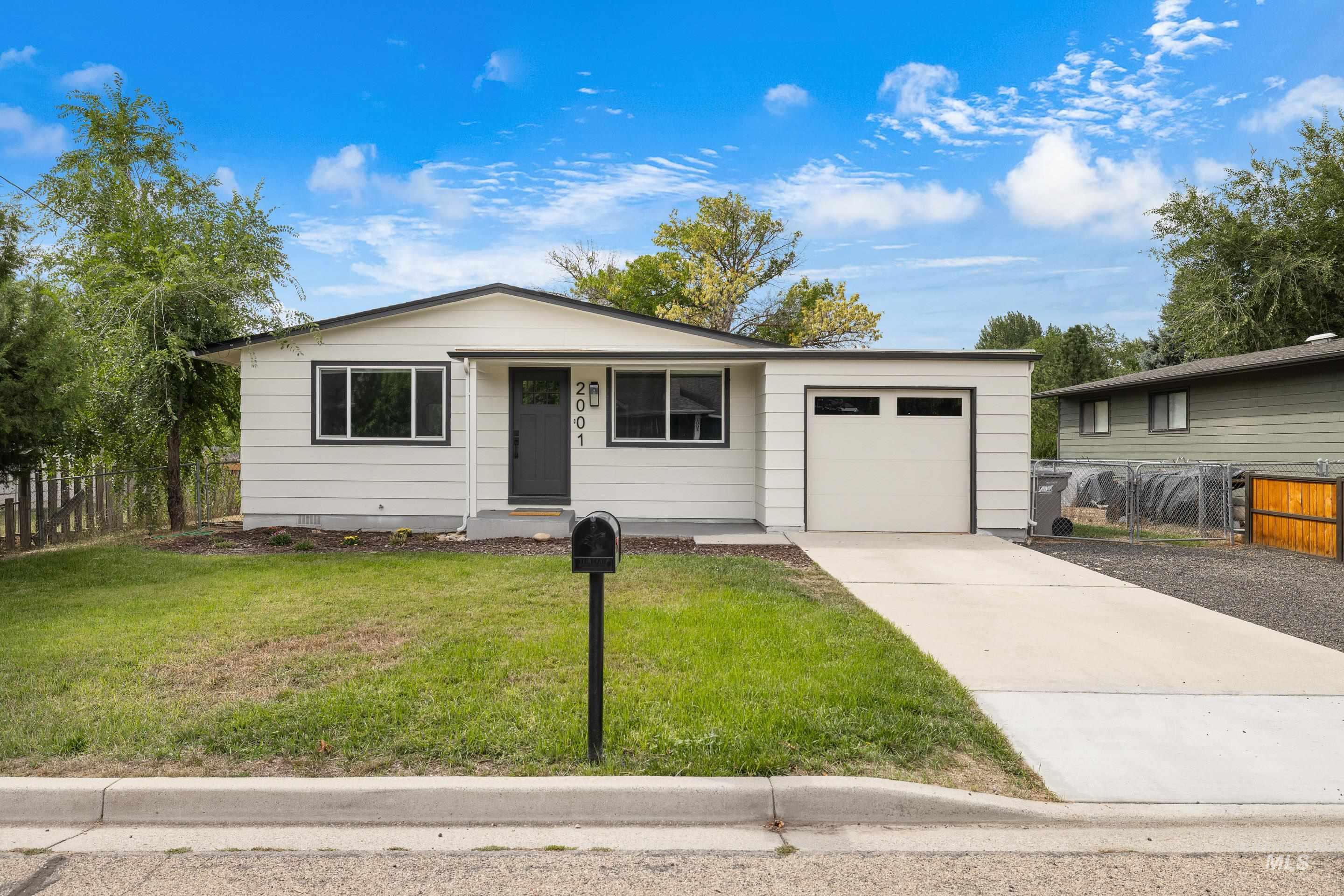 Ranch-style home with concrete driveway and a garage