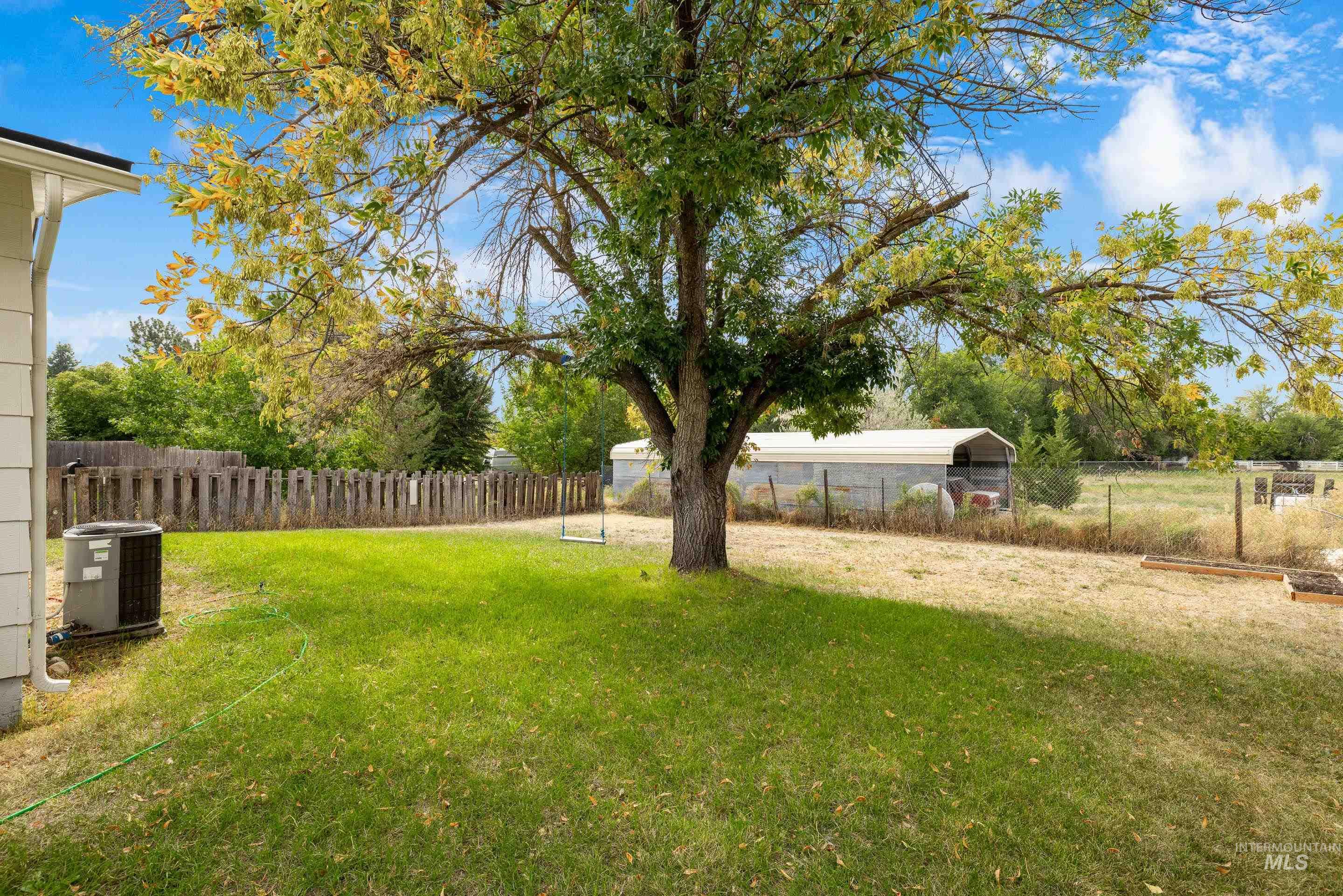 View of yard with a detached carport