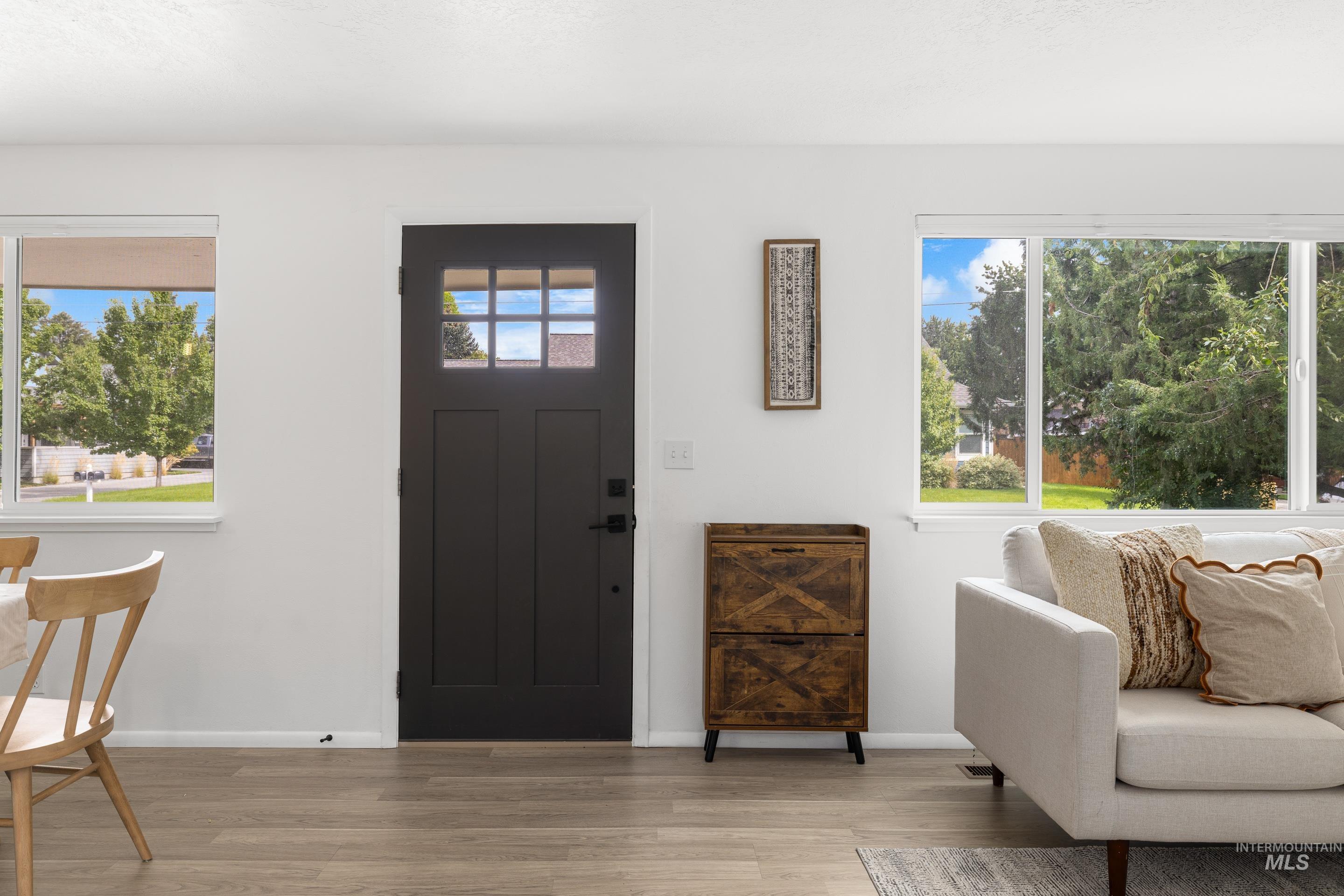 Foyer with wood finished floors and baseboards