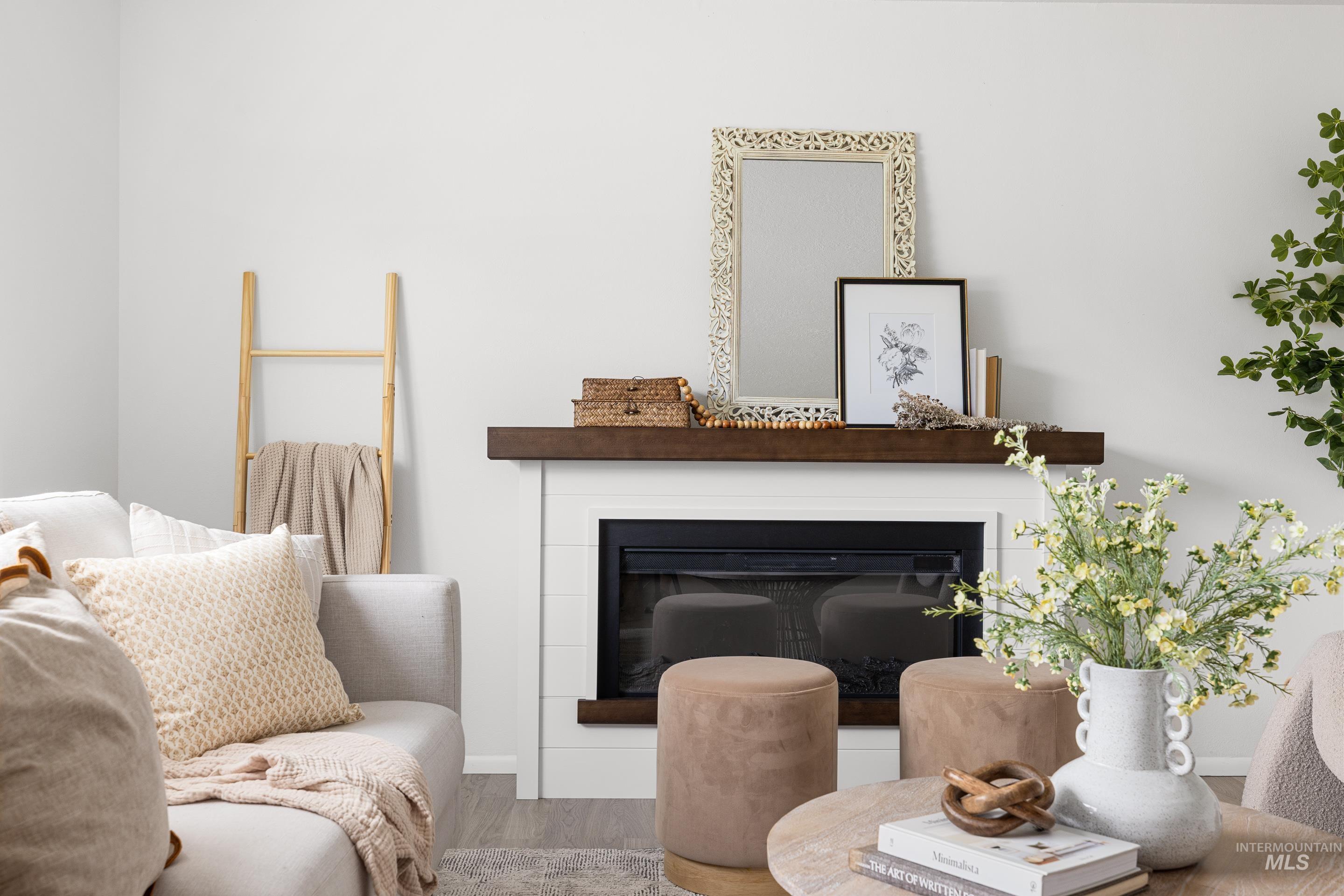 Living area featuring a glass covered fireplace and wood finished floors