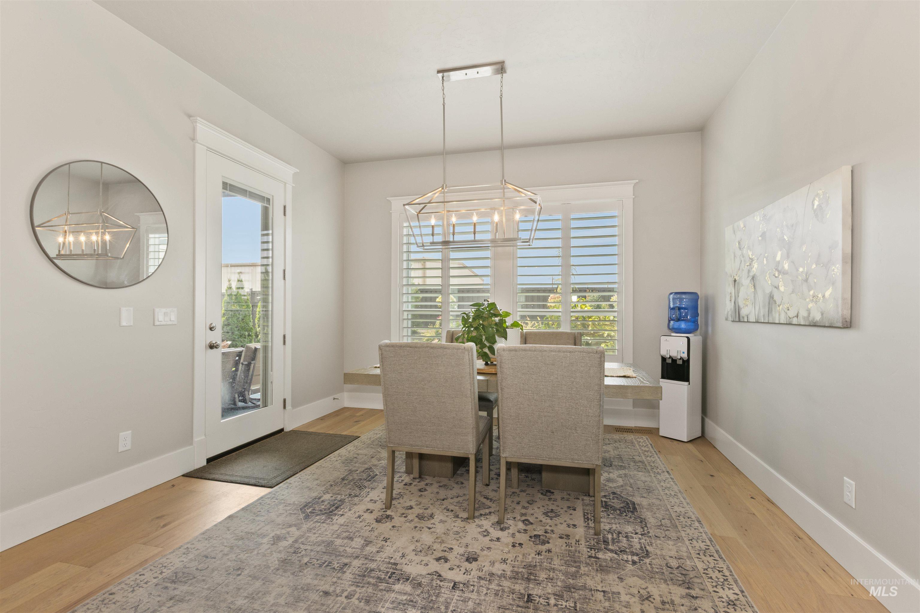 Dining space featuring a chandelier and light wood-type flooring