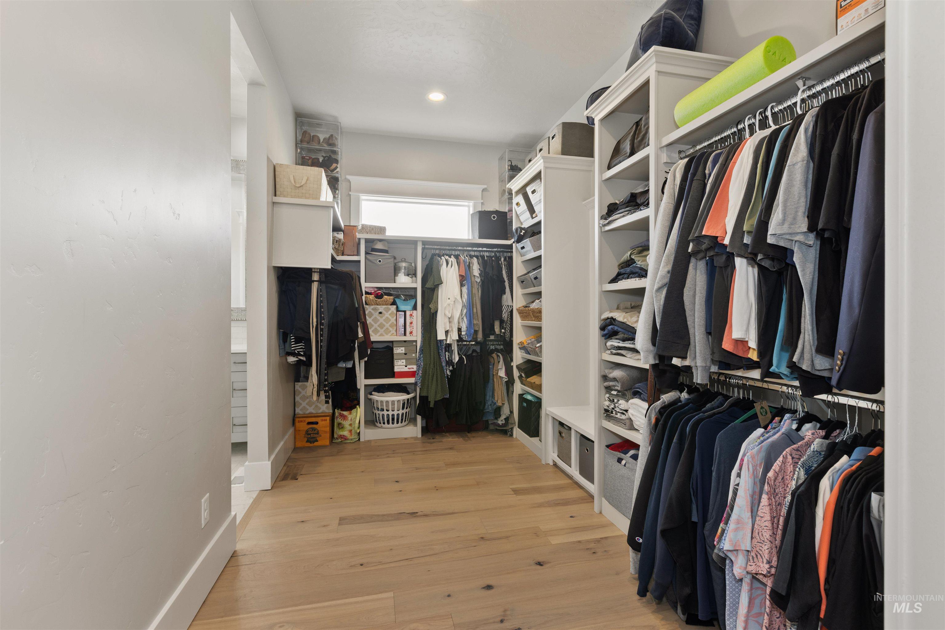 Walk in closet featuring light wood-style flooring