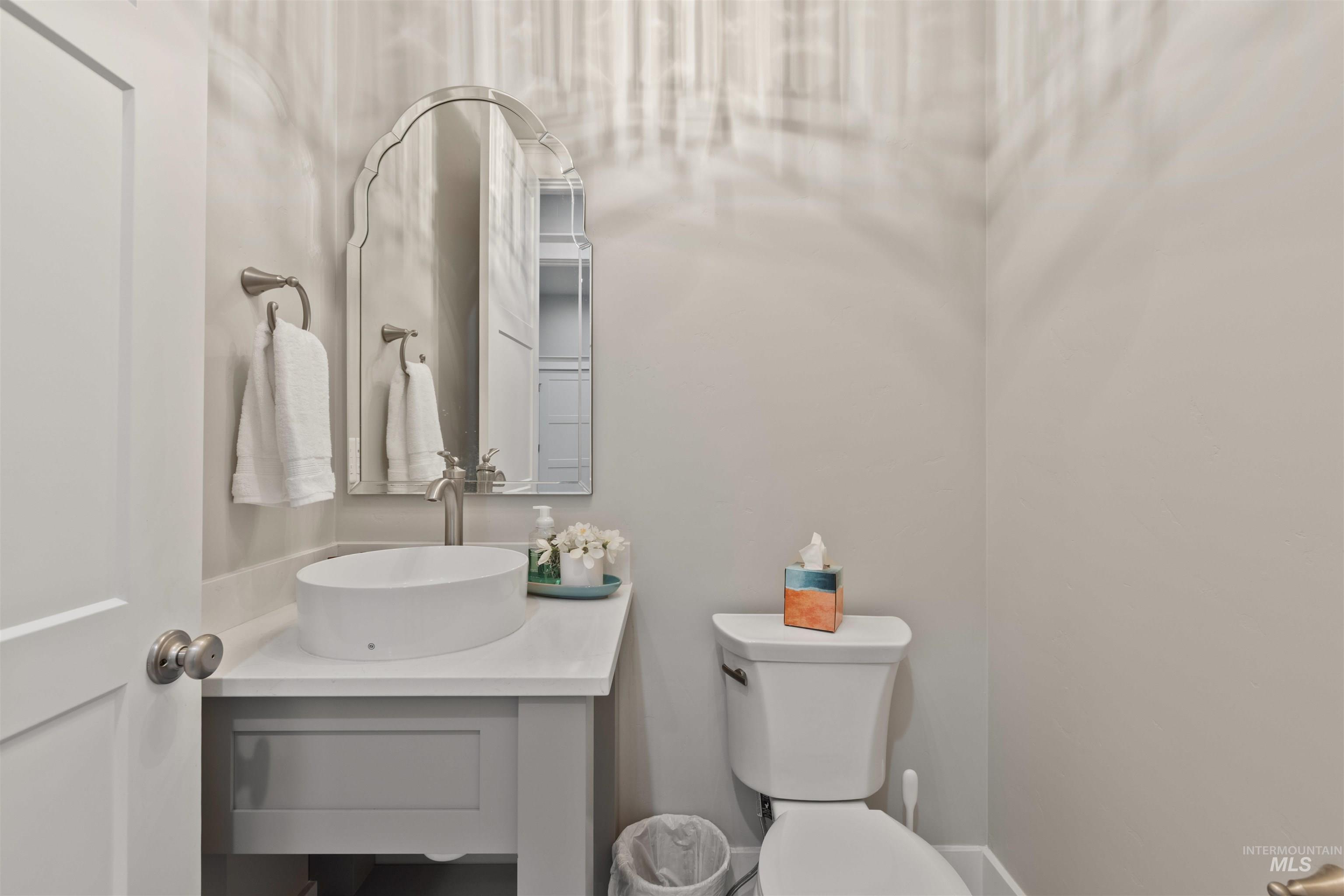 Half bathroom featuring vanity and toilet