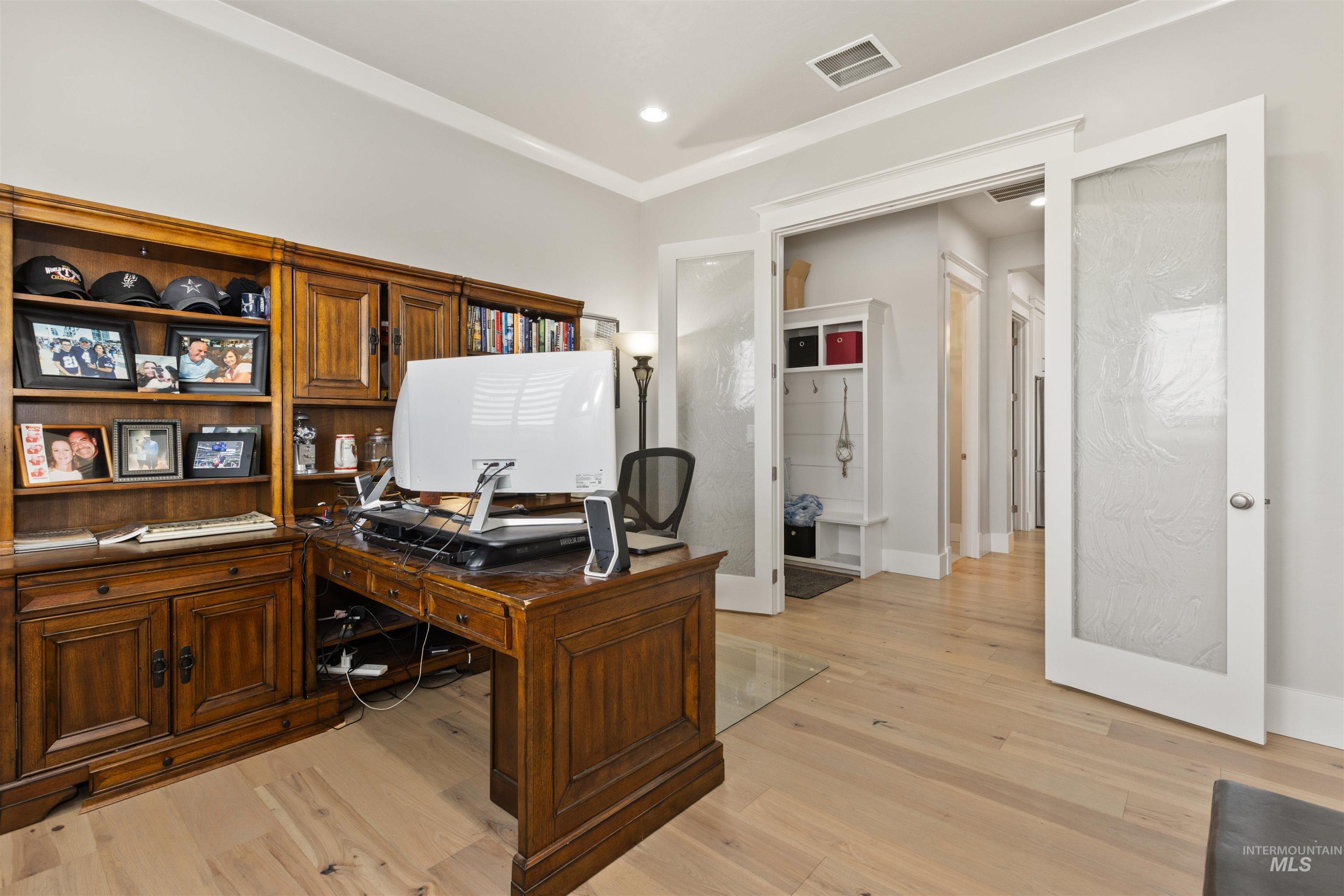 Office with light wood finished floors, french doors, and recessed lighting