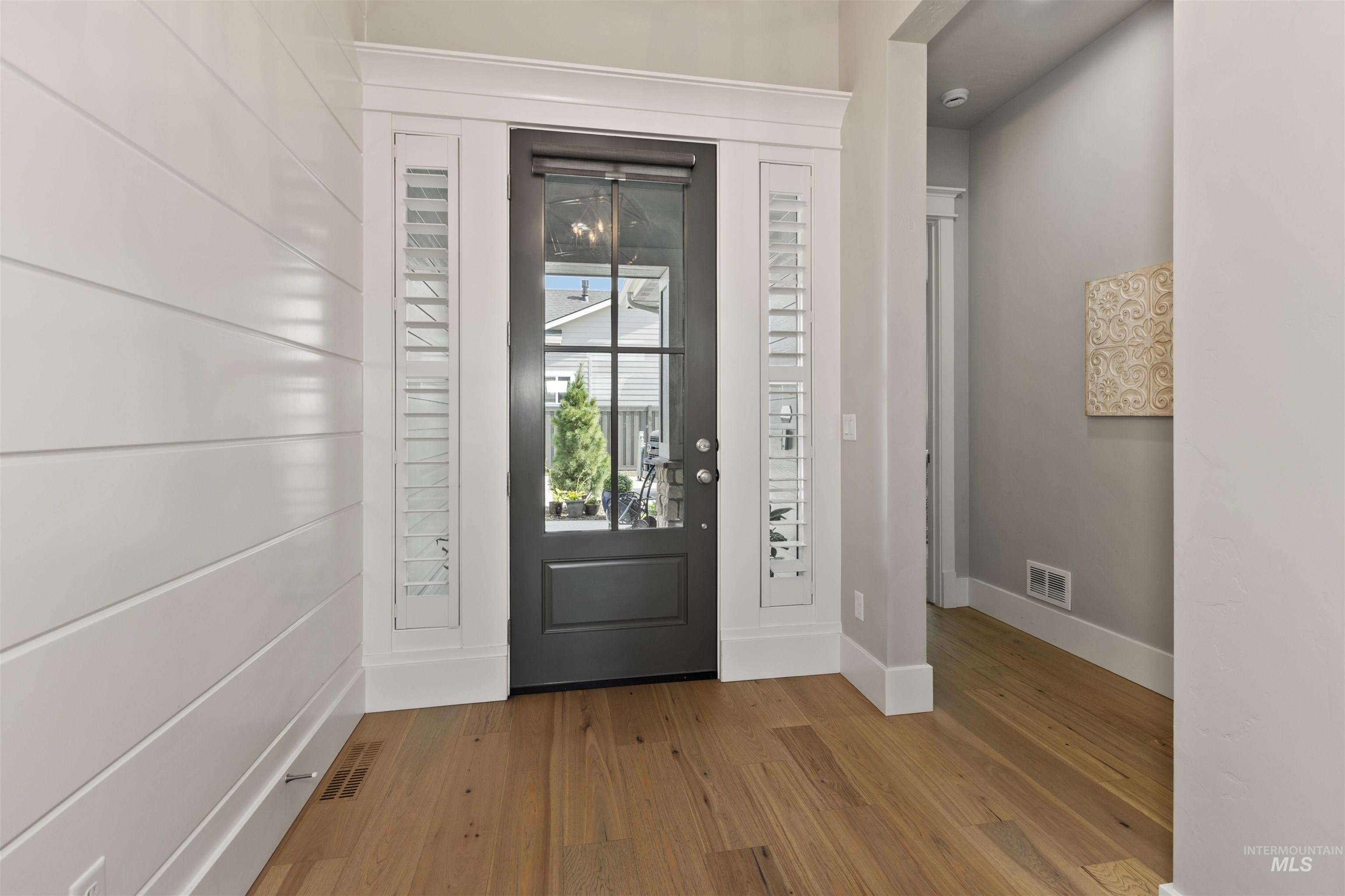 Foyer entrance featuring wood-type flooring and baseboards