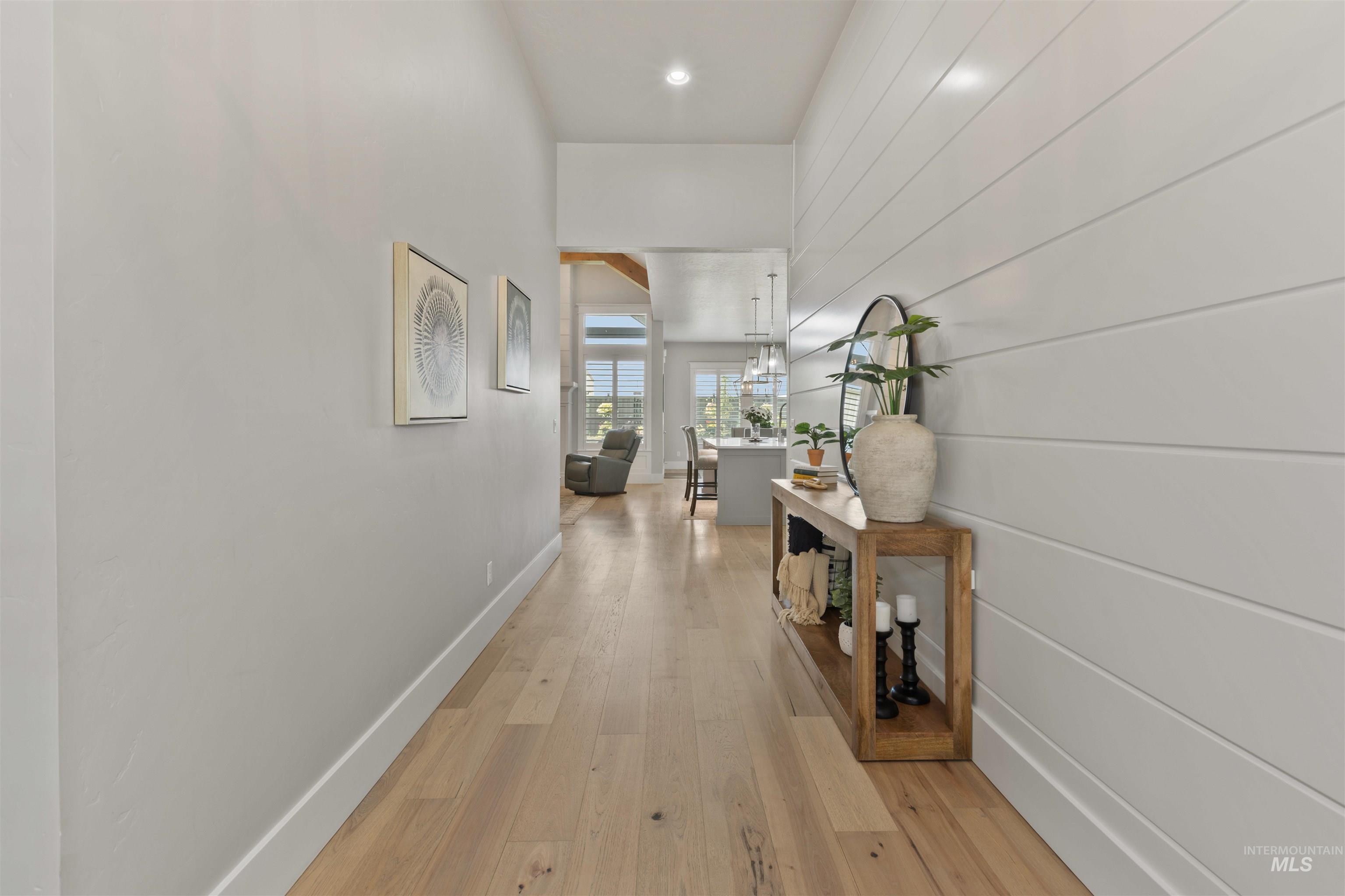 Hallway featuring light wood finished floors and baseboards