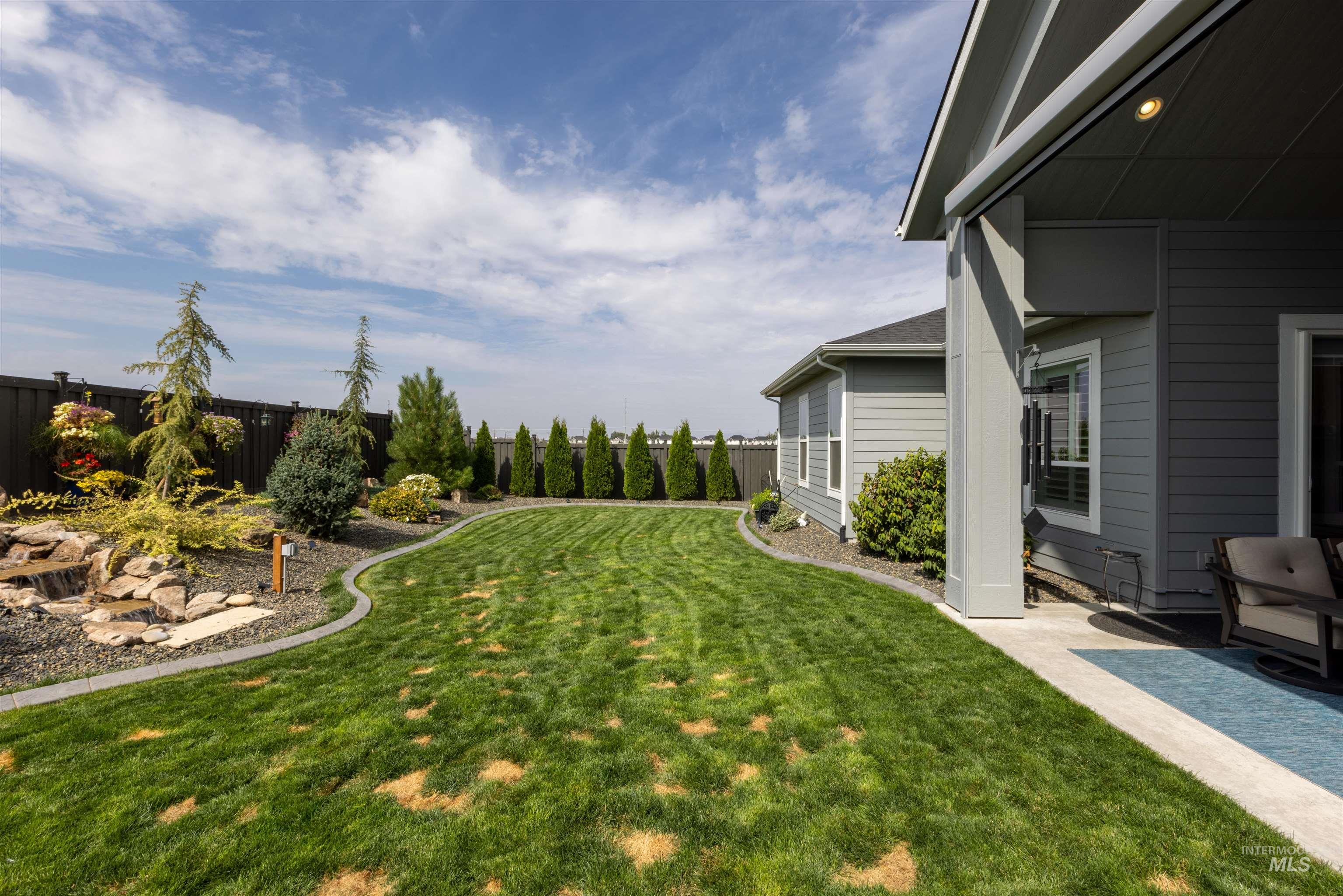 Fenced backyard with a patio