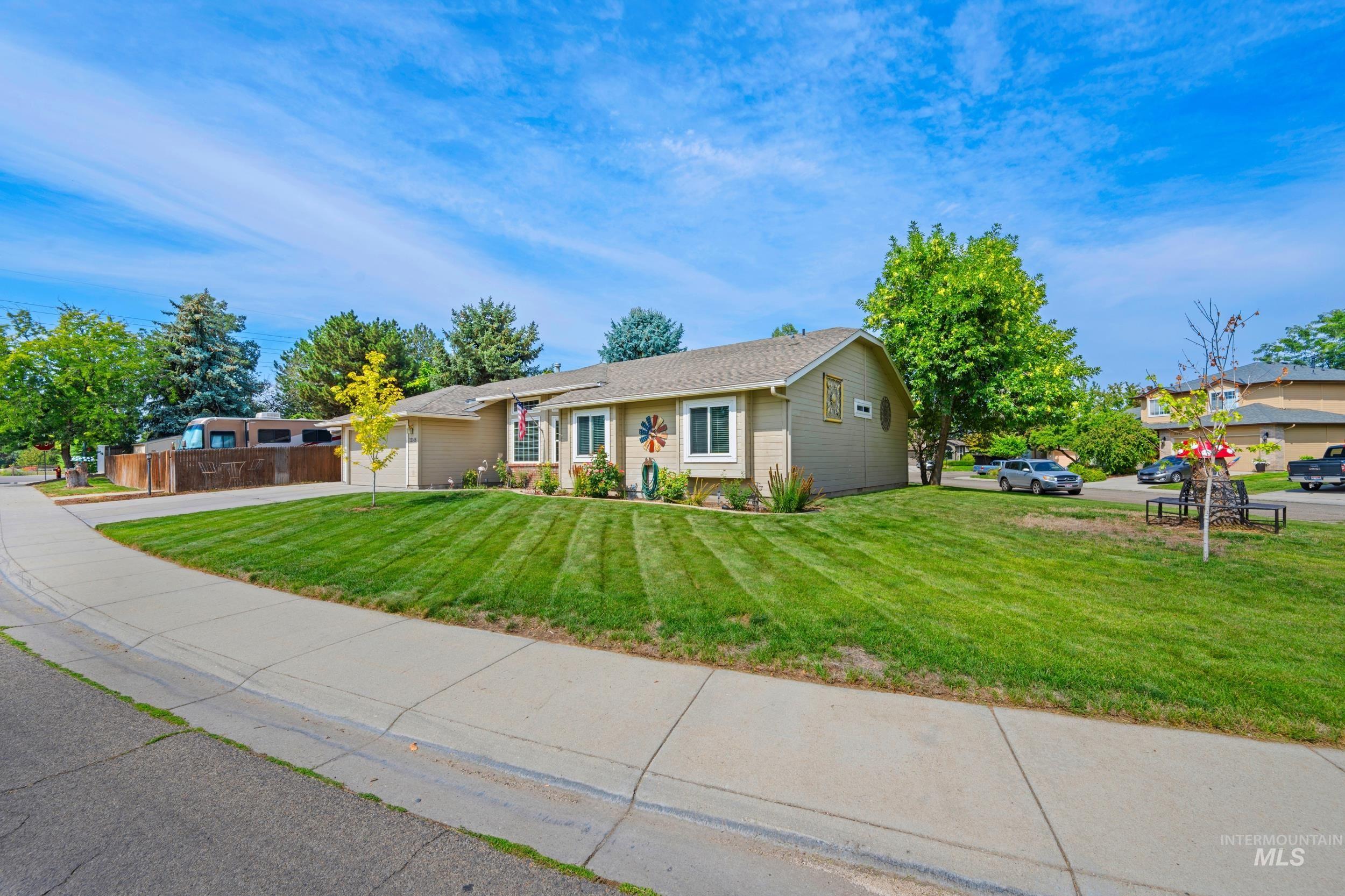 Ranch-style house featuring concrete driveway and an attached garage