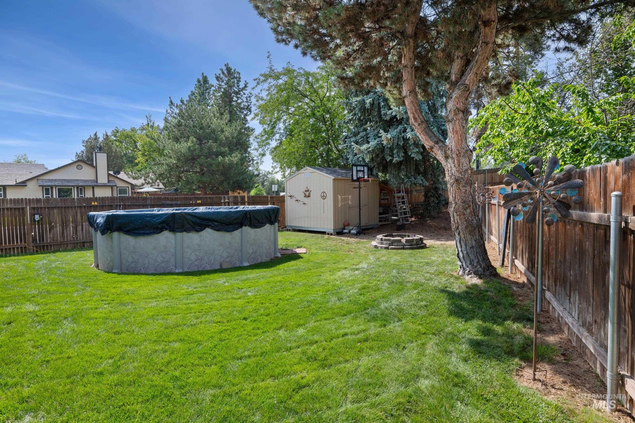 Fenced backyard with a shed