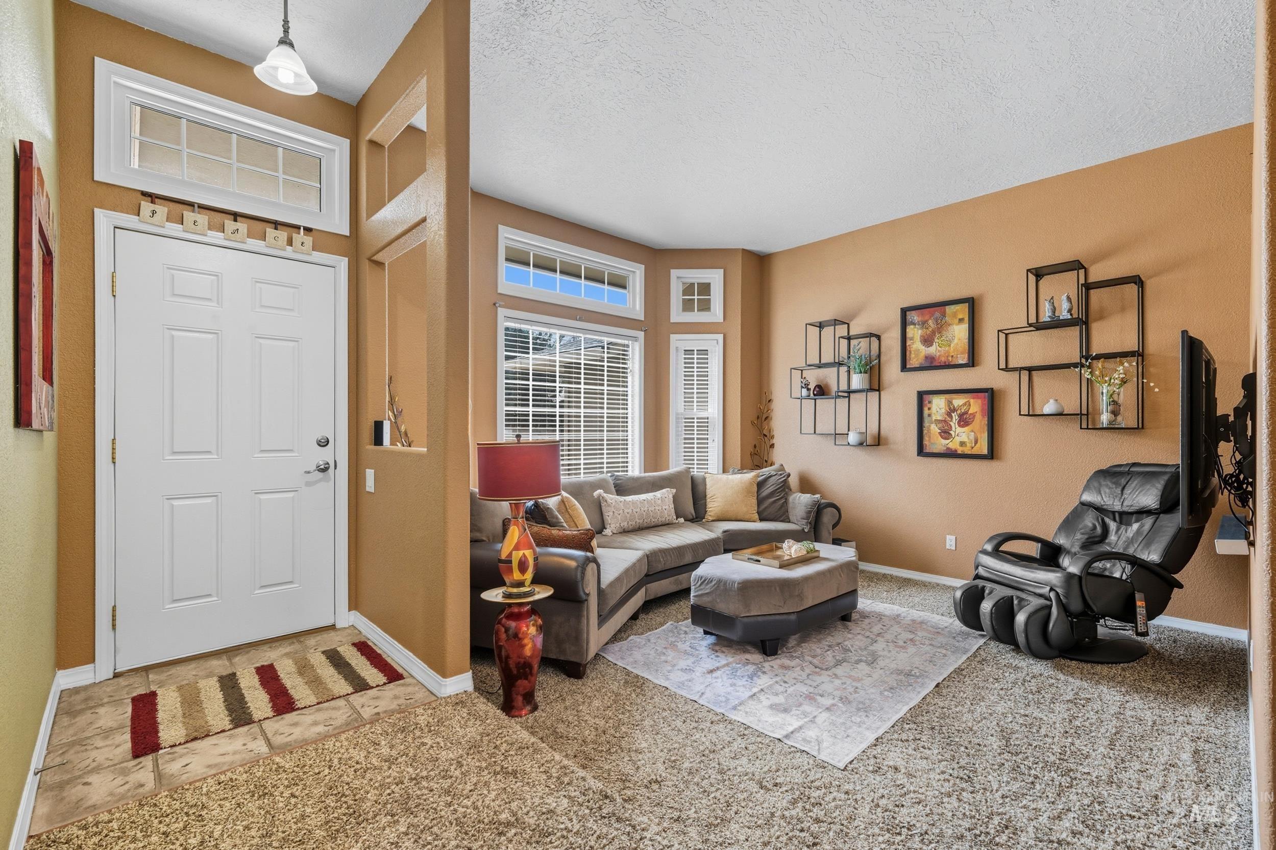 Living room featuring a textured ceiling and carpet