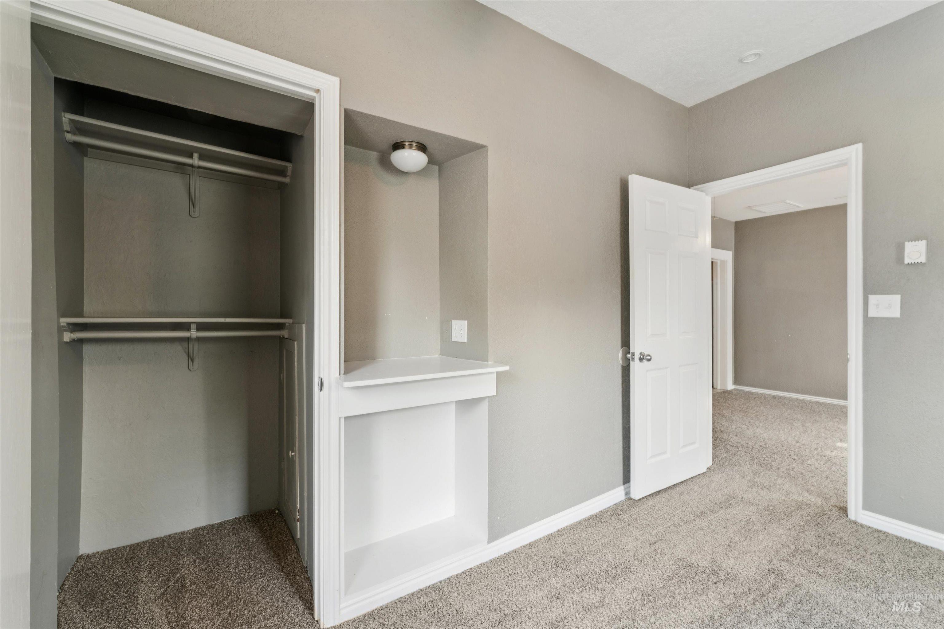 Unfurnished bedroom with carpet and a closet