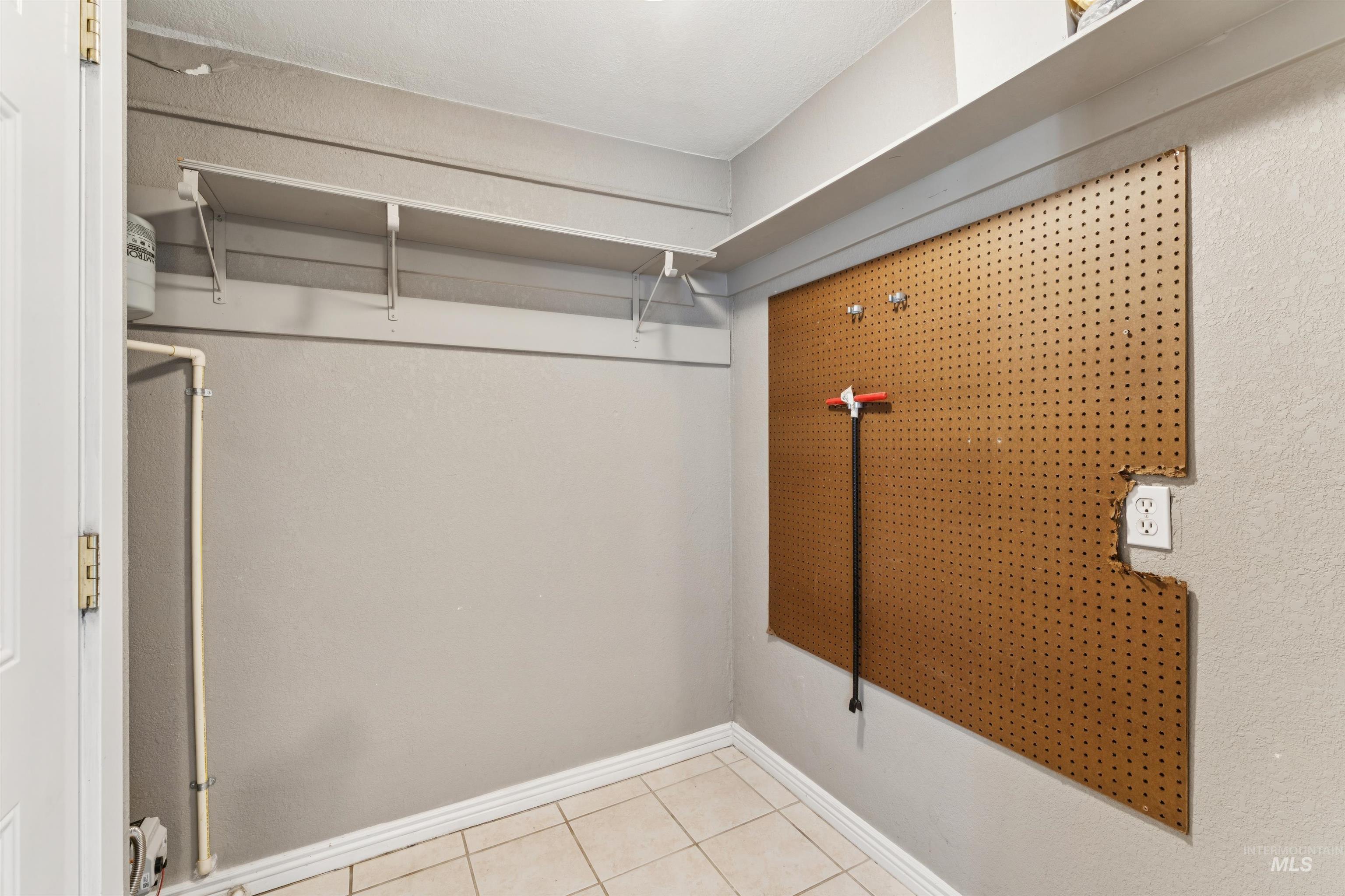 Walk in closet featuring light tile patterned floors