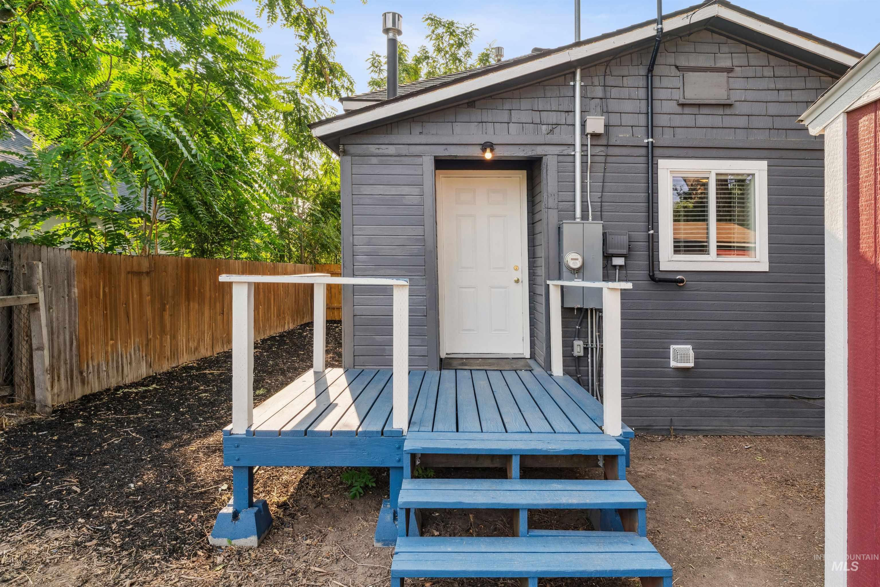 Rear view of house featuring a wooden deck