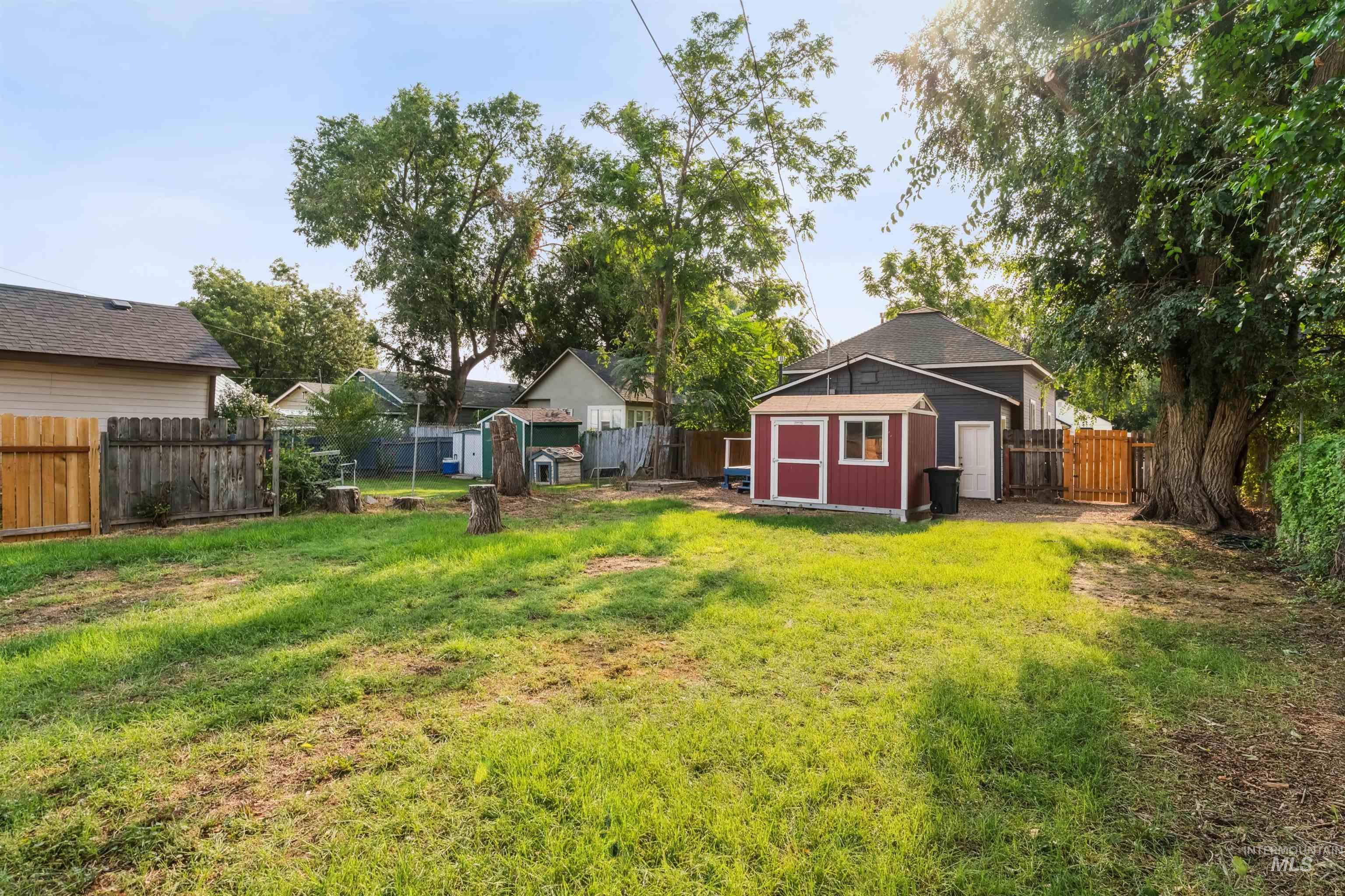 Fenced backyard with a storage unit