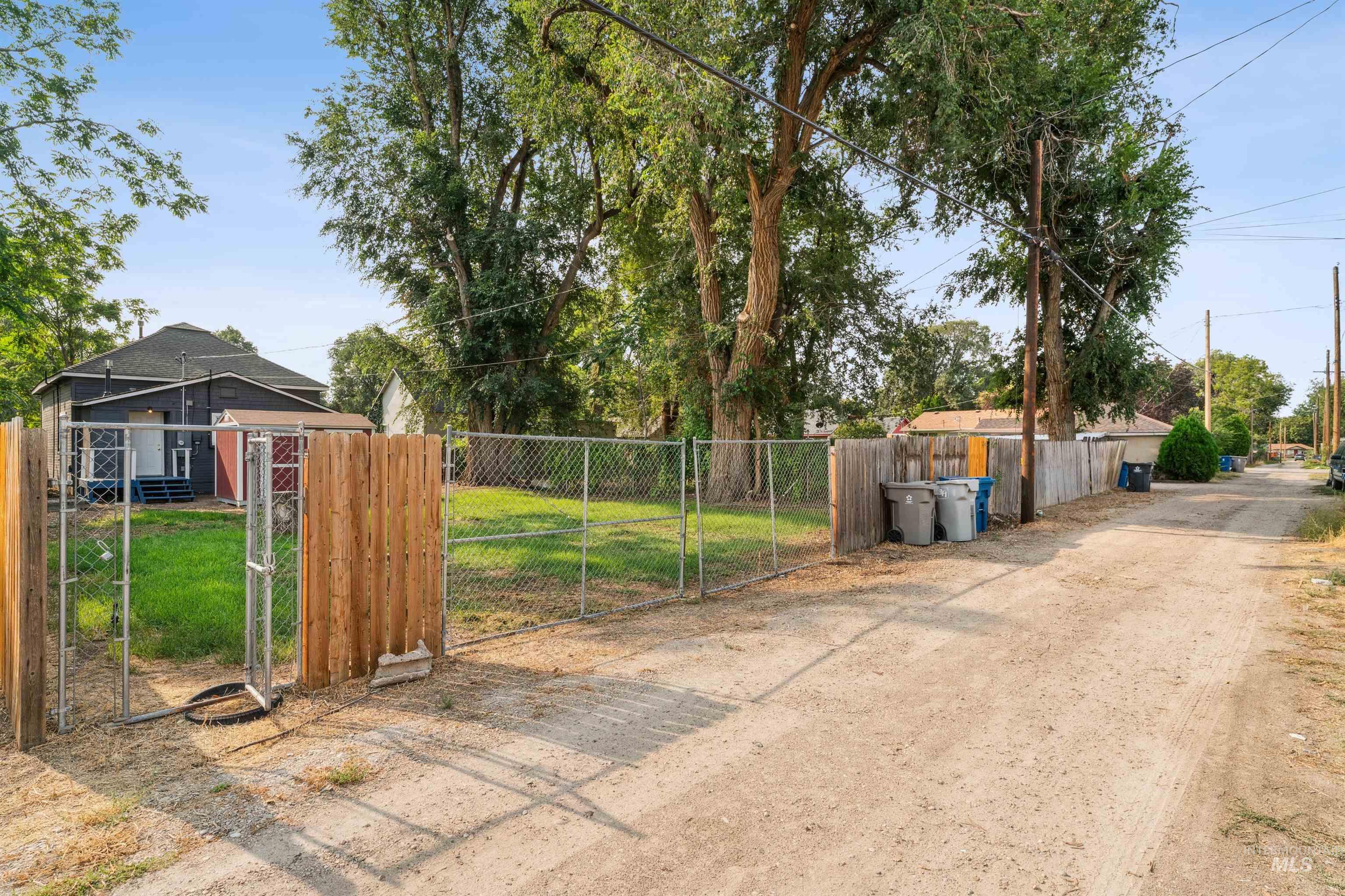View of dirt / gravel road featuring a gate