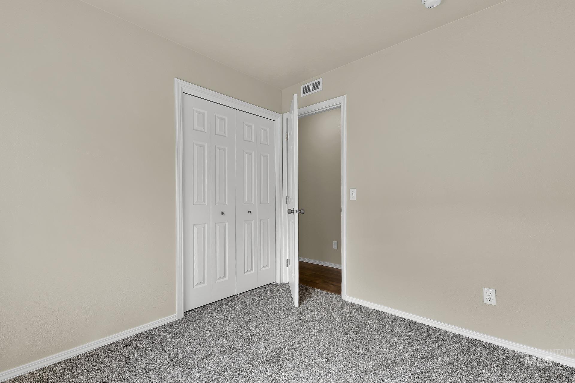 Unfurnished bedroom with carpet floors and a closet