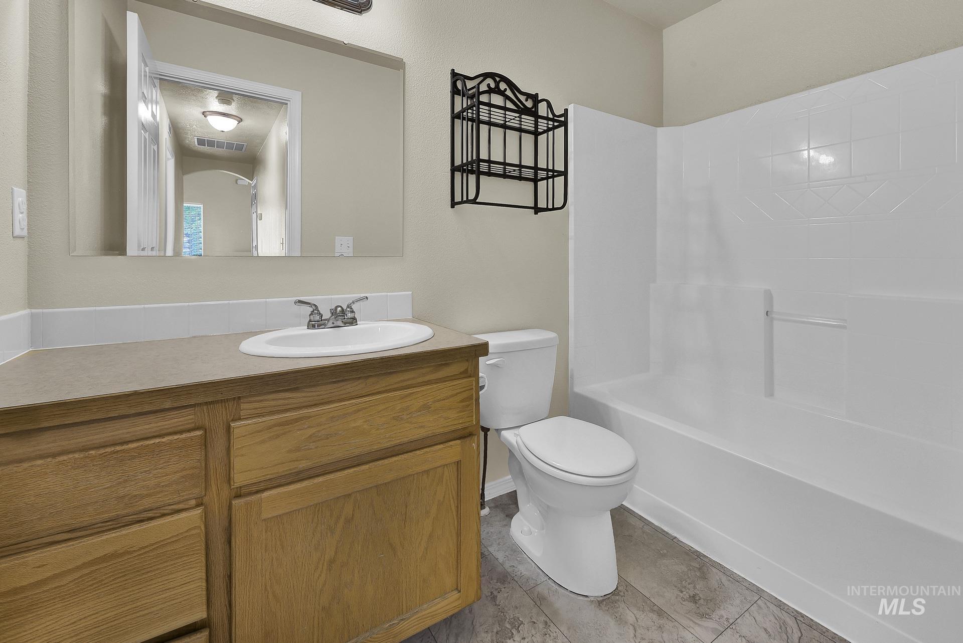 Full bath with vanity and bathtub / shower combination