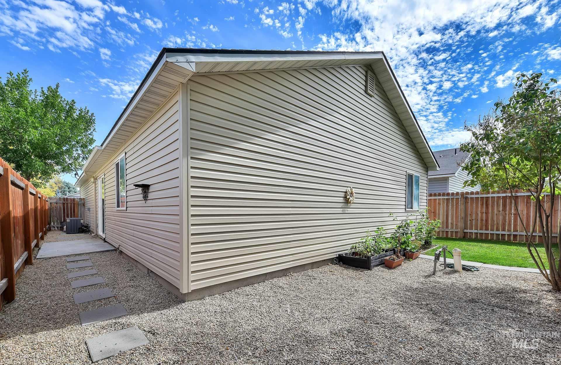 View of side of home featuring a fenced backyard