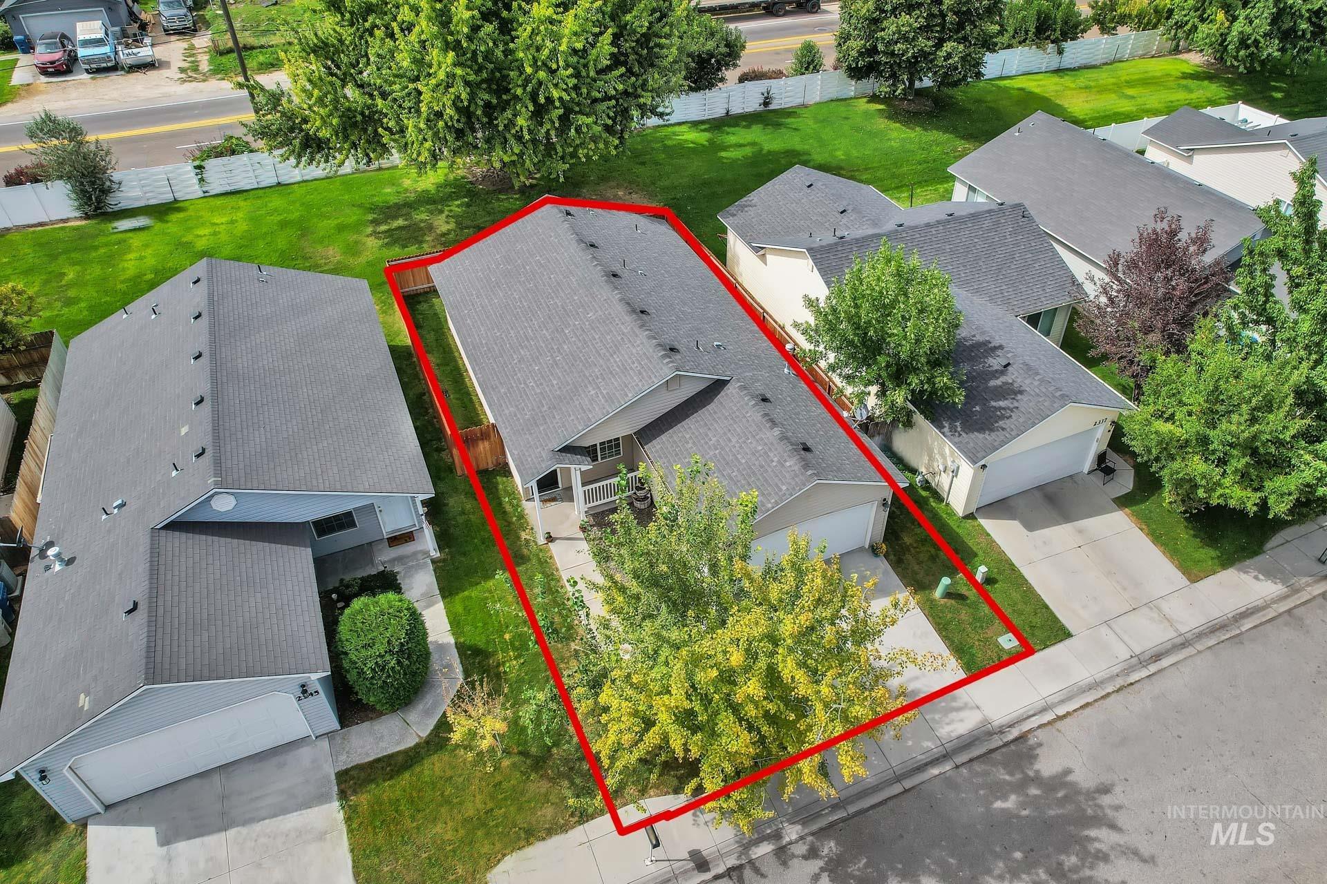 Aerial view of residential area with property boundaries highlighted