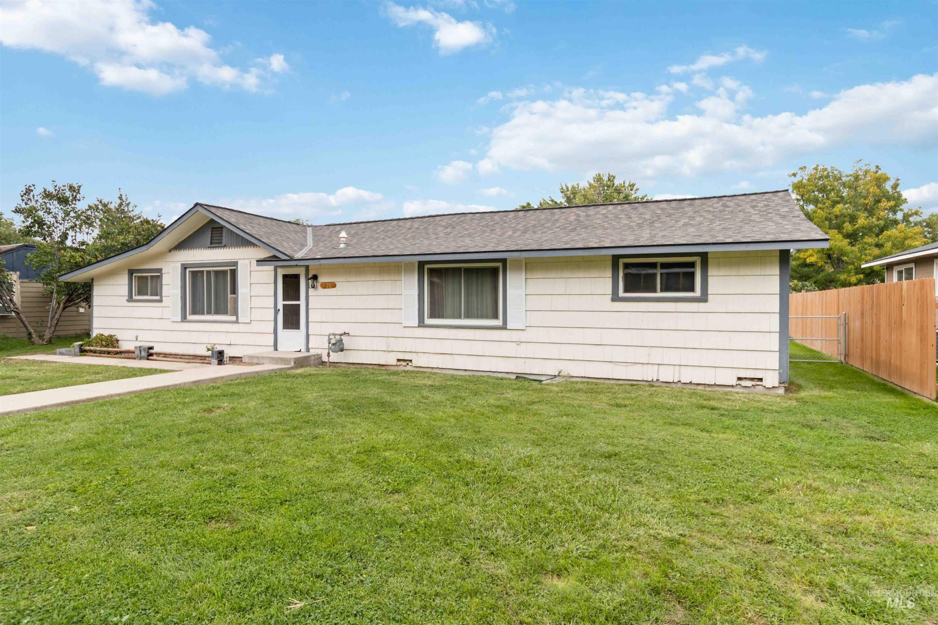 Ranch-style home with roof with shingles