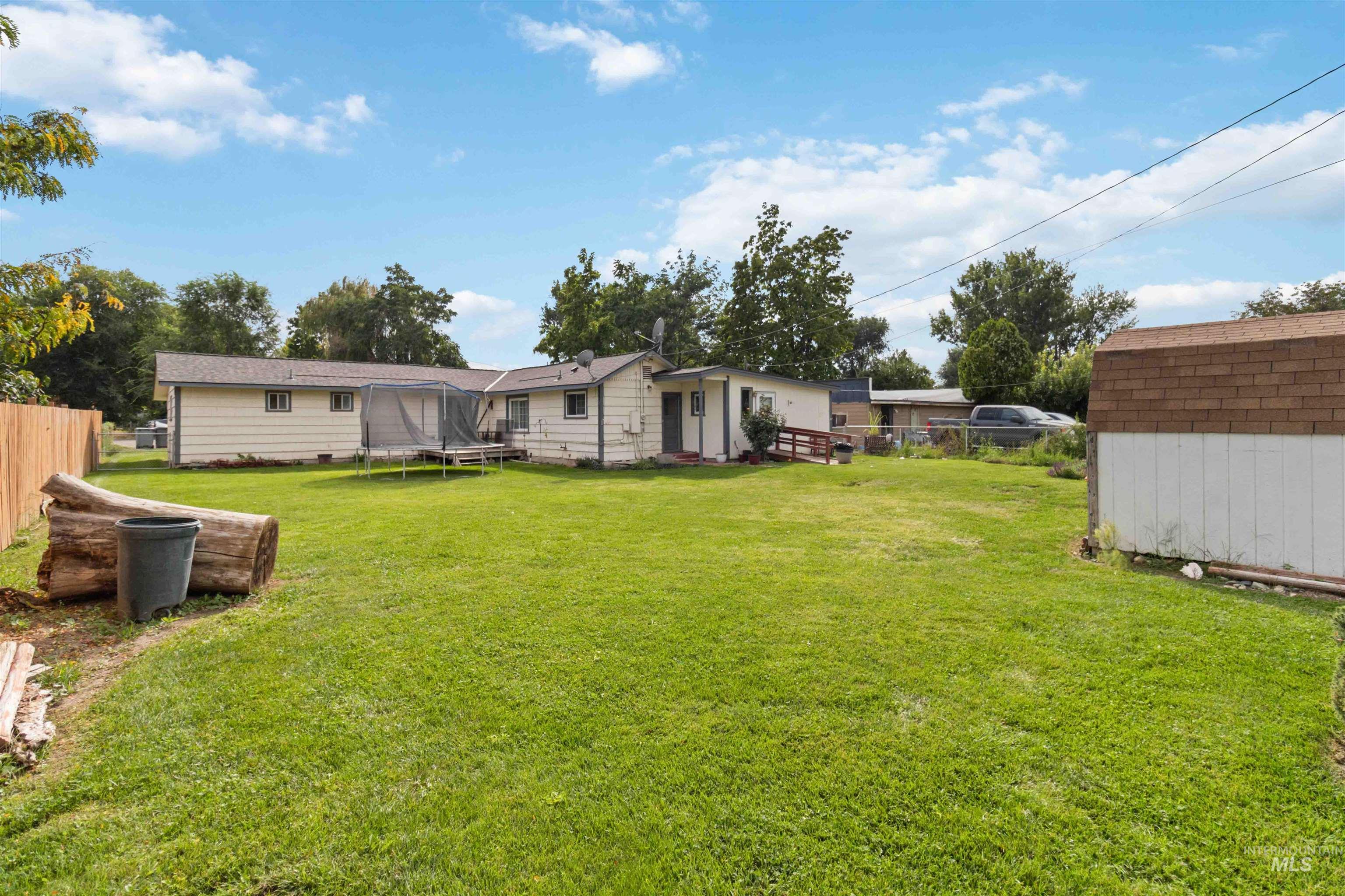 View of yard with a trampoline and an outdoor structure