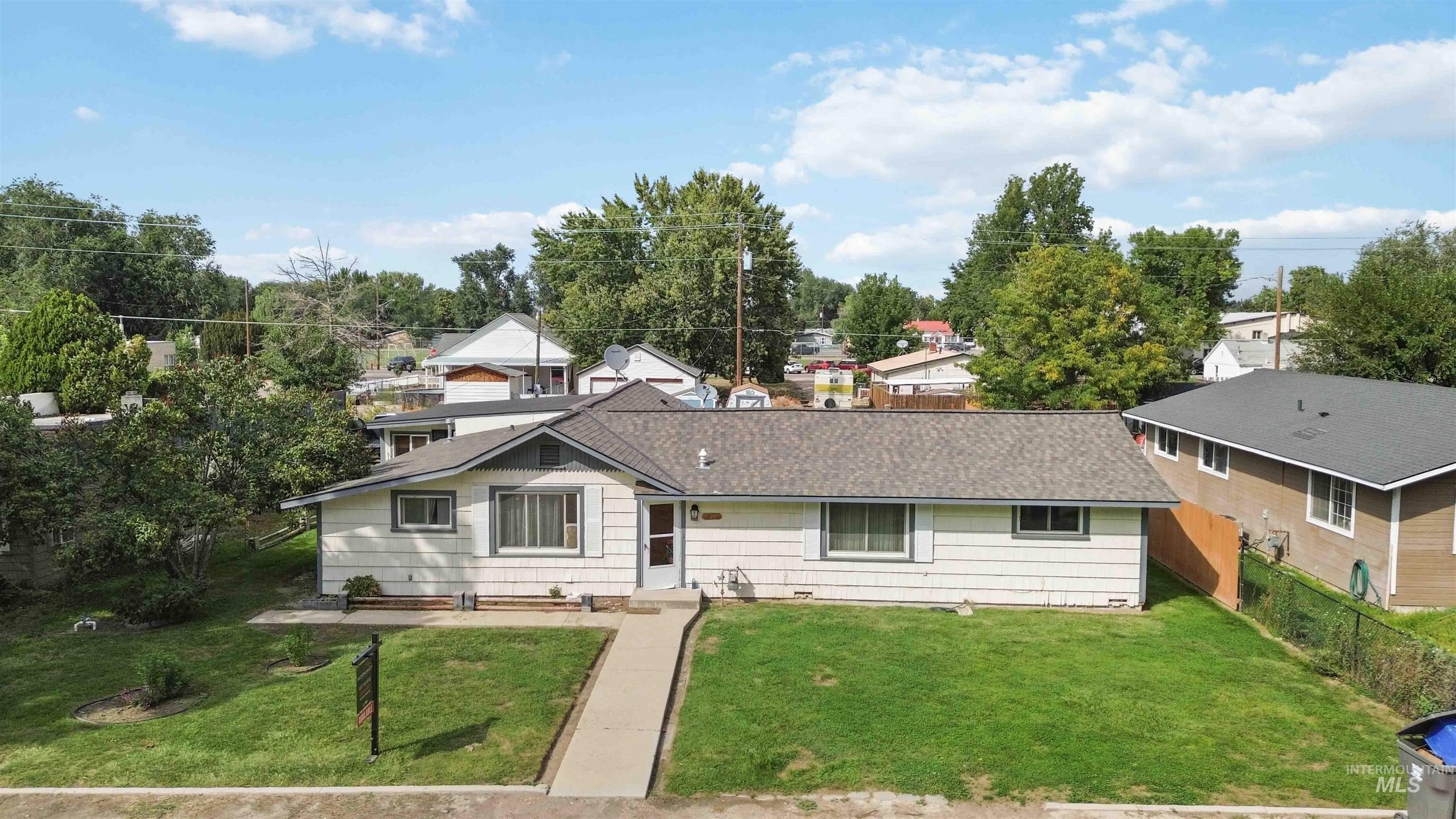View of front of house with a shingled roof and a residential view