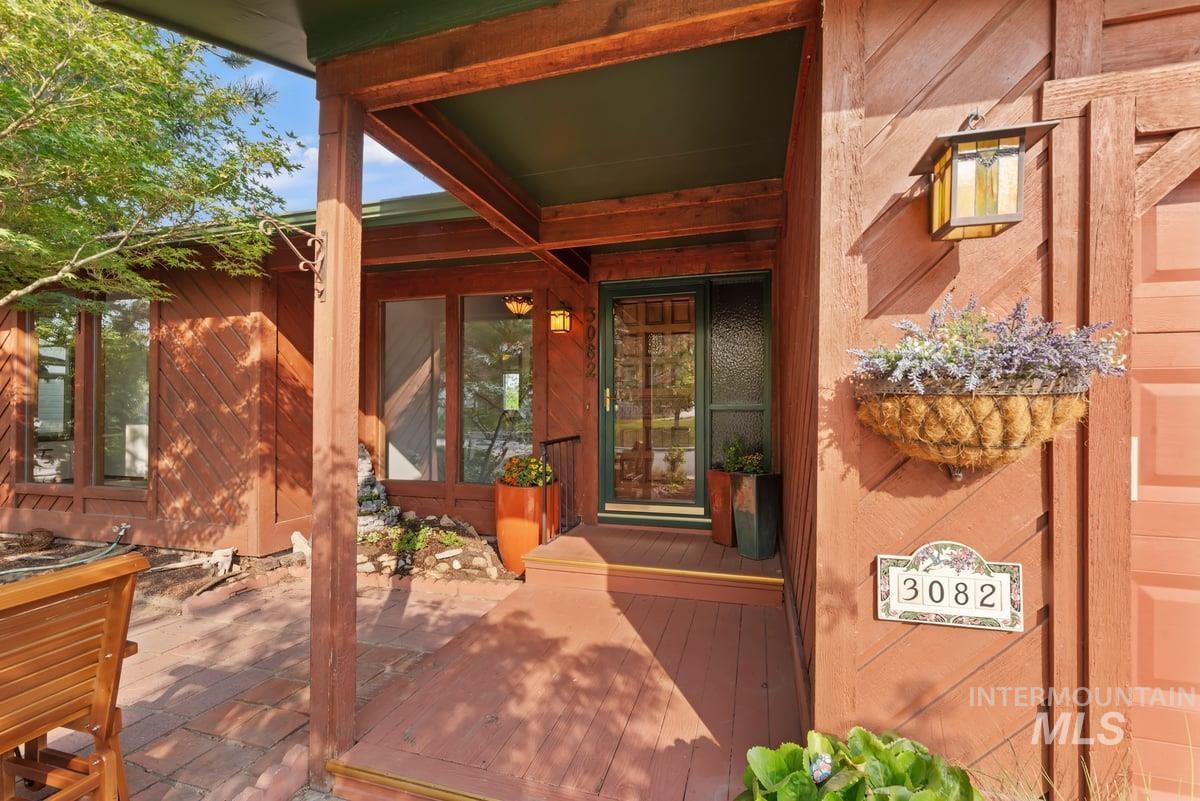 Doorway to property with a patio area