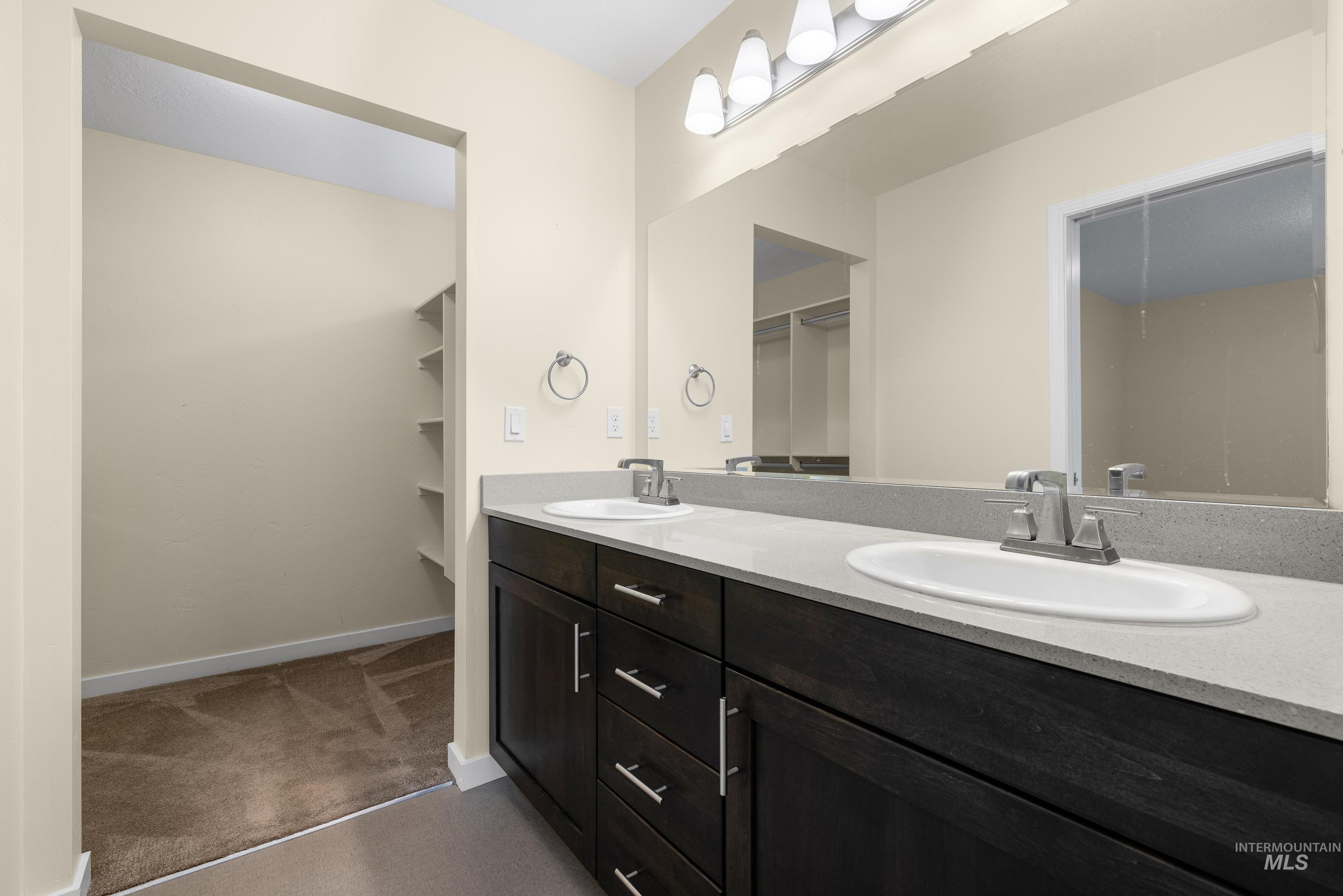 Bathroom with a spacious closet and double vanity