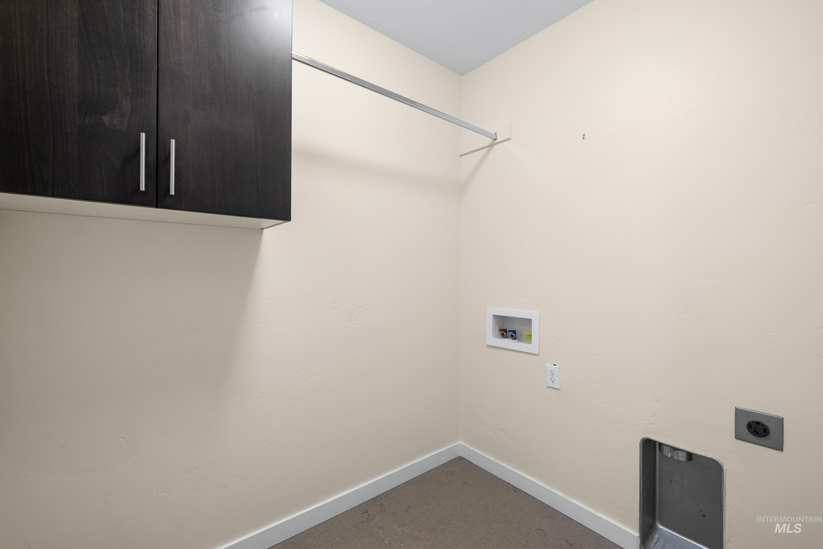 Washroom with cabinet space, washer hookup, and electric dryer hookup