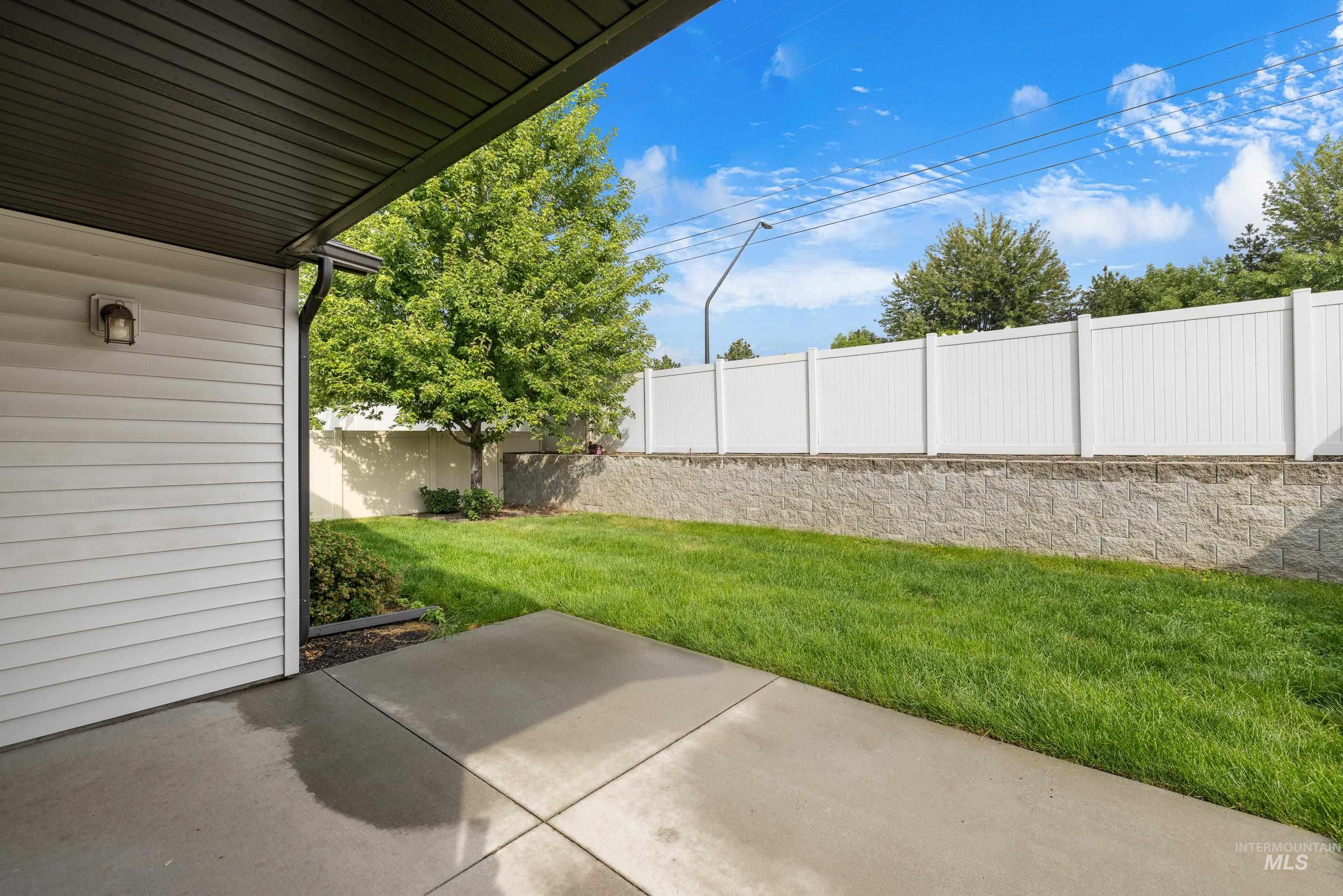Fenced backyard with a patio area