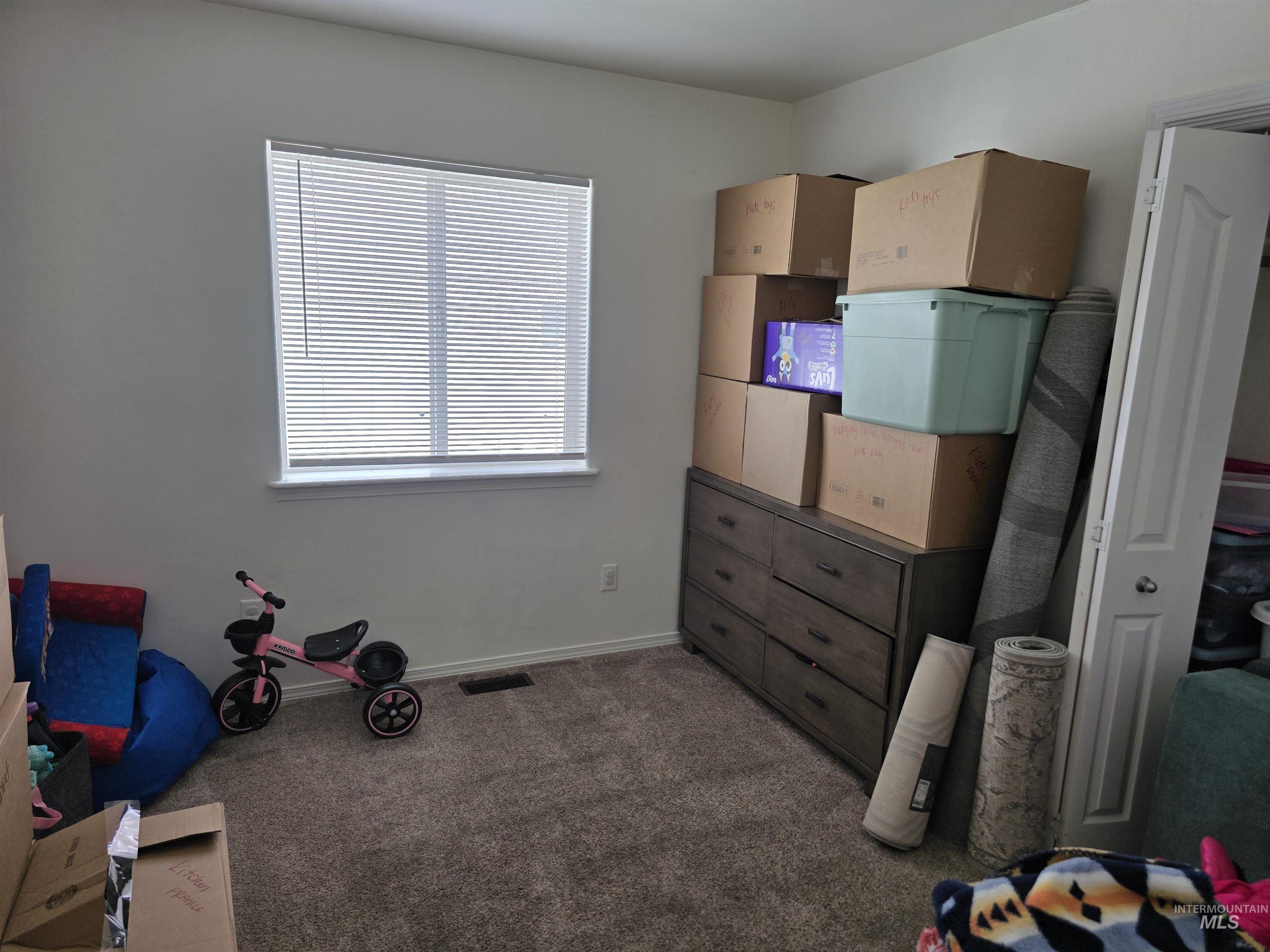 Workout area featuring dark colored carpet and baseboards