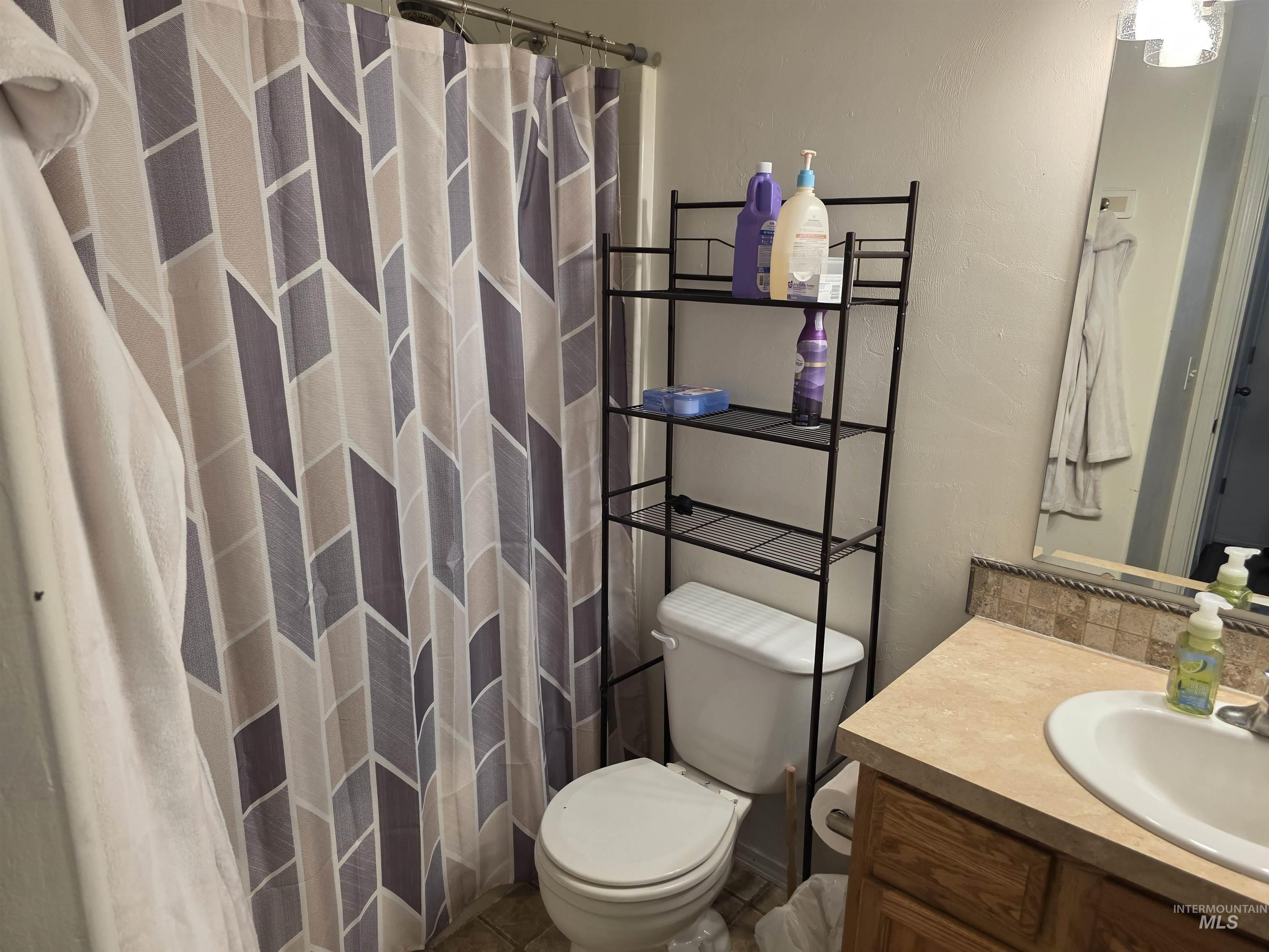 Bathroom with vanity and curtained shower