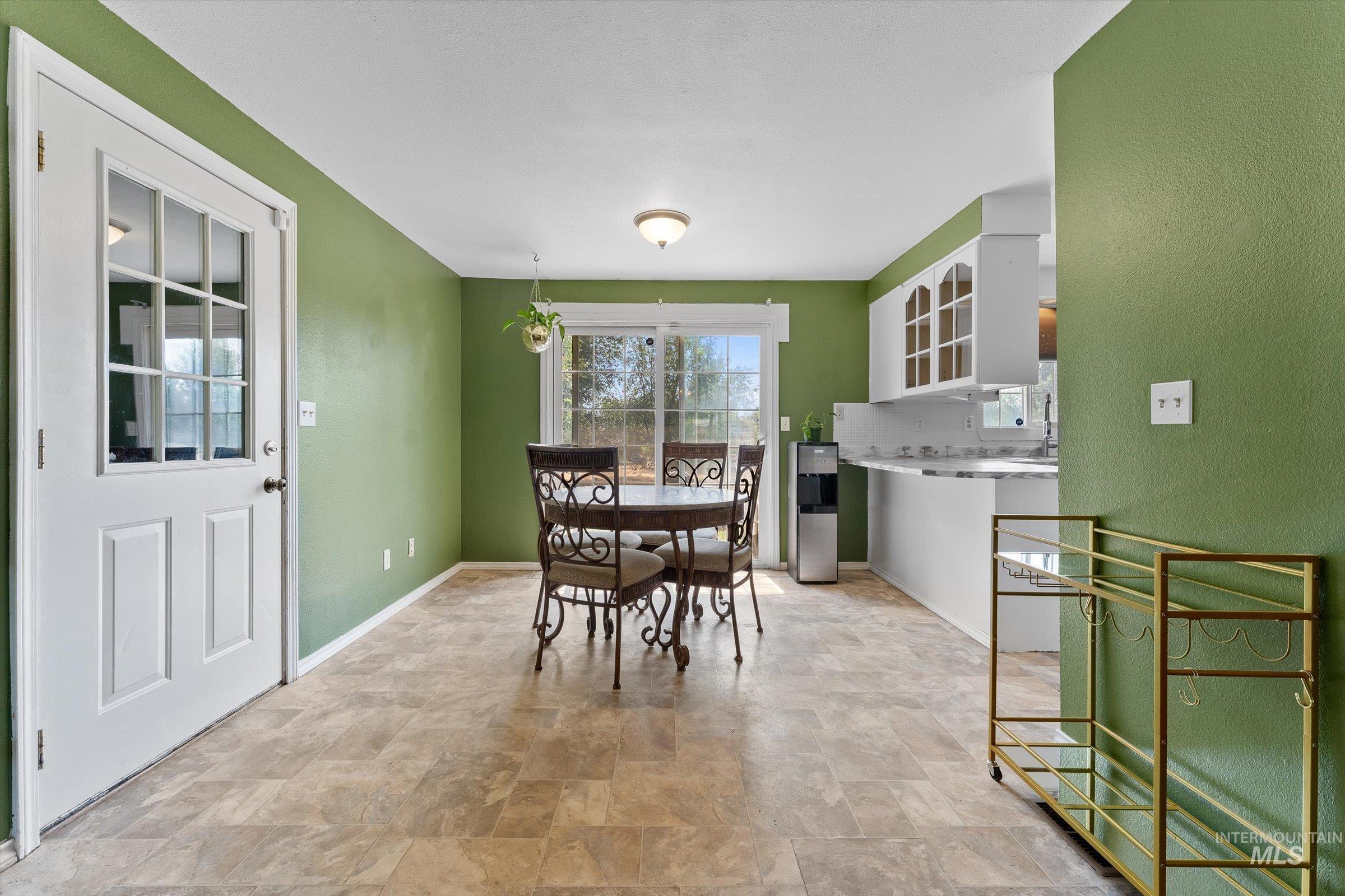 Dining space featuring stone finish floors and baseboards