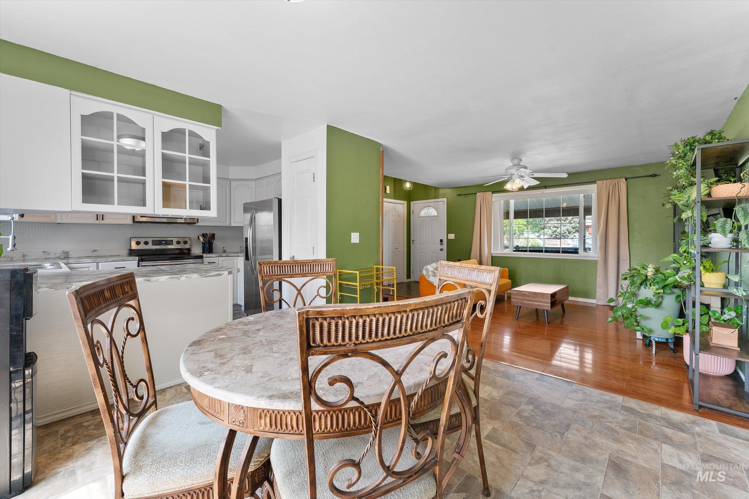 Dining area featuring a ceiling fan and stone finish flooring