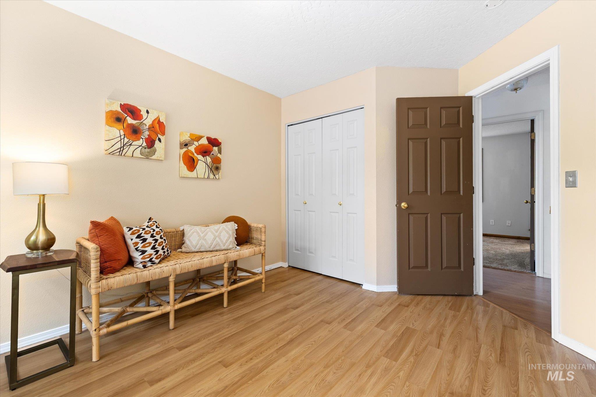 Sitting room with light wood-style floors and baseboards
