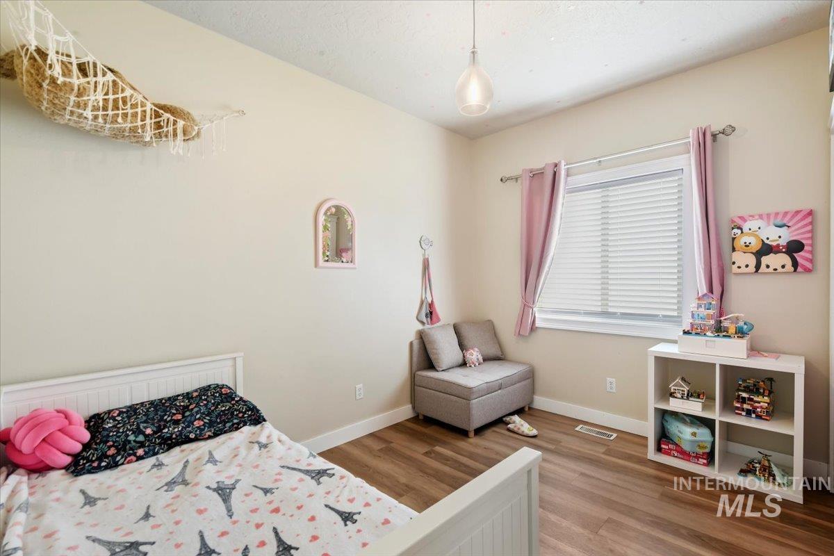 Bedroom featuring light wood-type flooring and baseboards