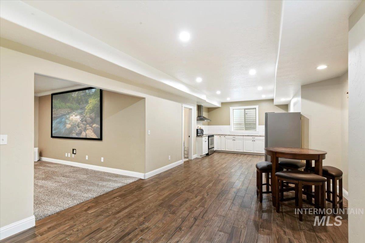 Dining room featuring dark wood-style flooring and recessed lighting