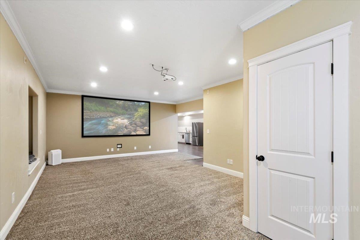 Cinema featuring crown molding, light colored carpet, and recessed lighting