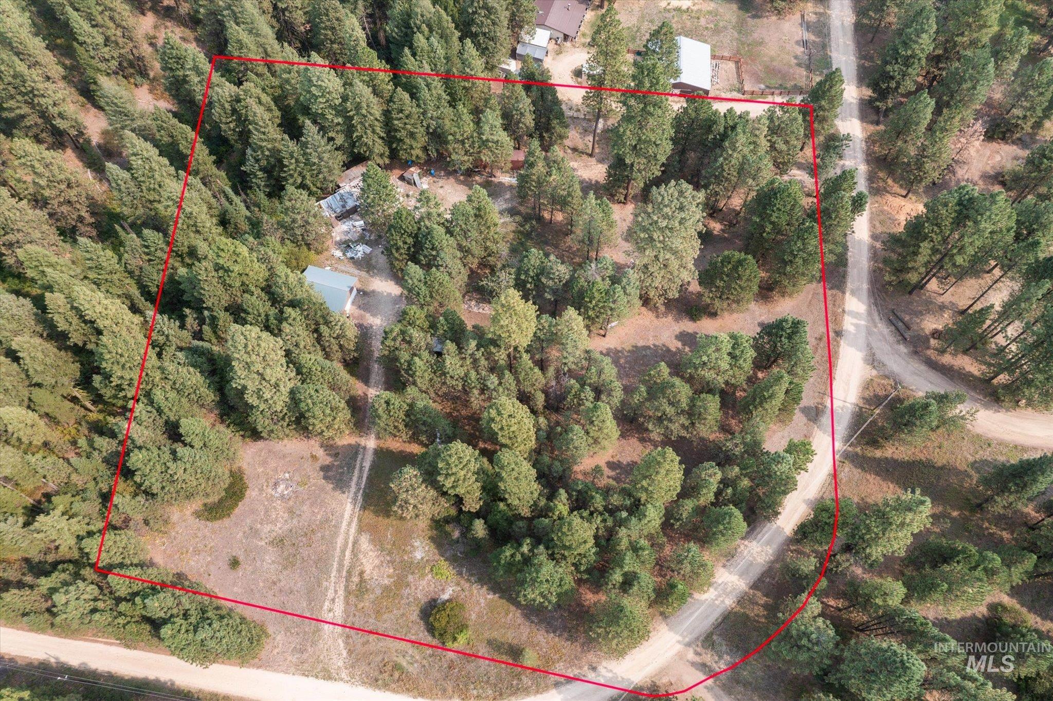 Aerial view of property and surrounding area featuring property parcel outlined