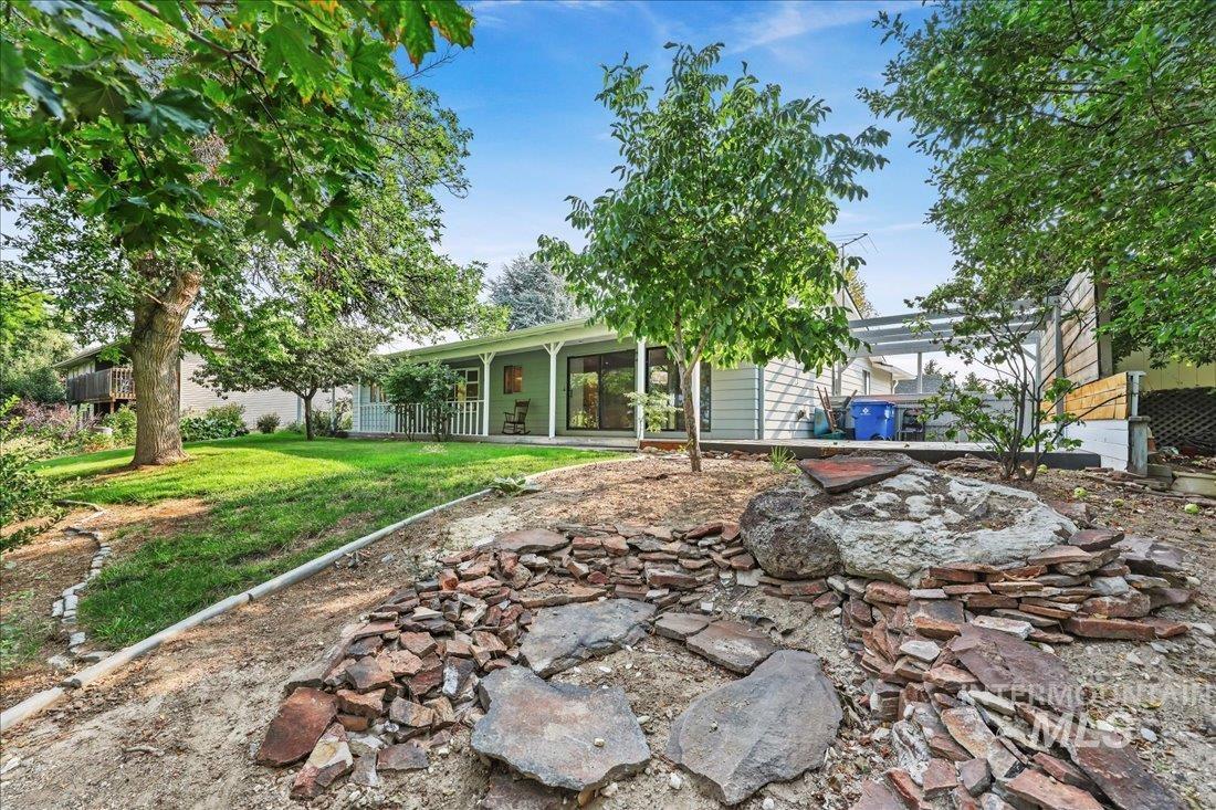 Rear view of house with a yard and a patio