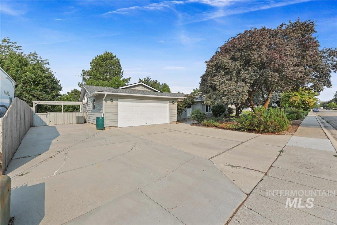 View of property exterior with a garage and concrete driveway