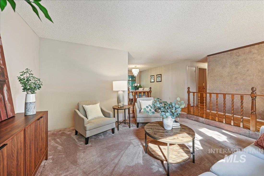 Carpeted living area with a textured ceiling